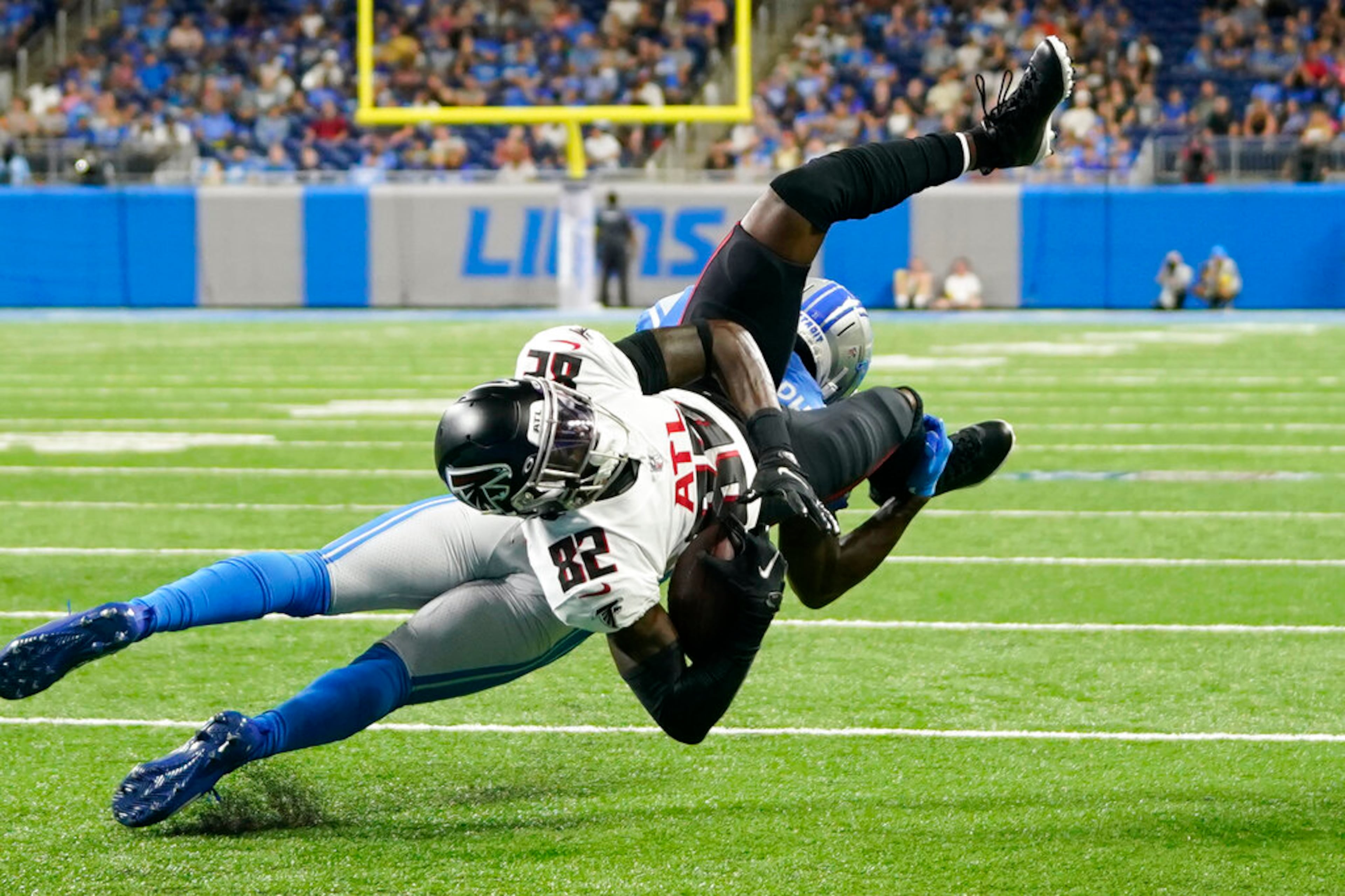 Detroit Lions safety Kerby Joseph upends Atlanta Falcons wide receiver Geronimo Allison (82) short of the goal line during the first half of a preseason NFL football game, Friday, Aug. 12, 2022, in Detroit. (AP Photo/Paul Sancya)