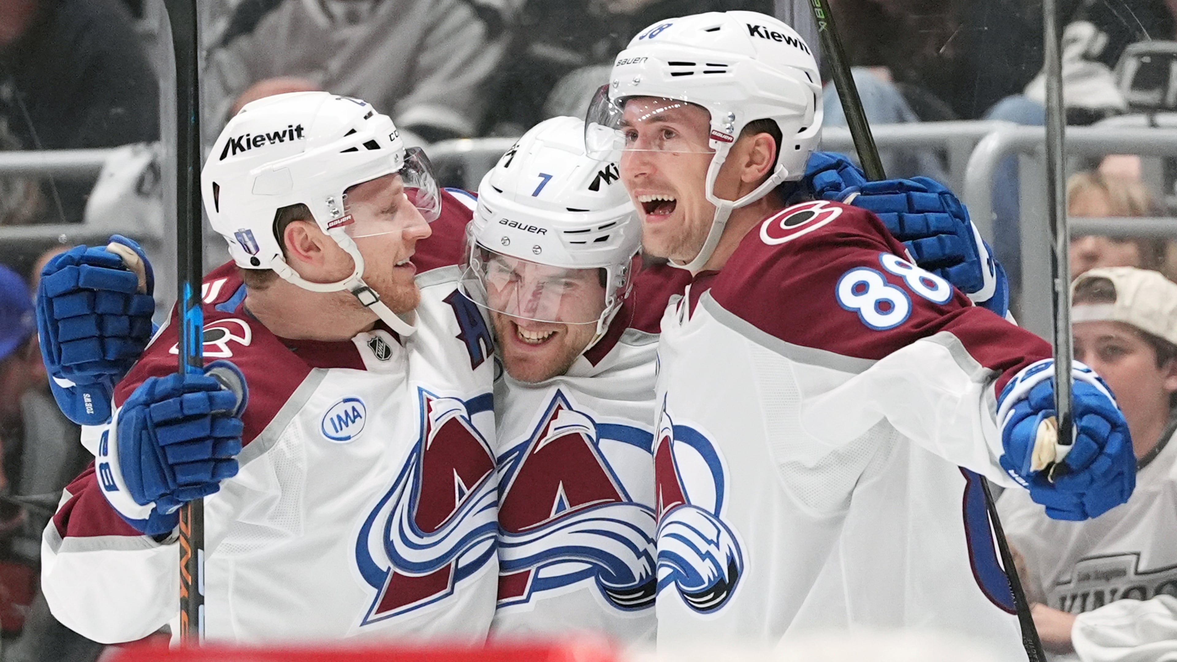 Colorado Avalanche's Devon Toews (7) celebrates his goal with Nathan MacKinnon (29) and Martin Necas (88) against the Los Angeles Kings during the third period of Game 4 in the first round of an NHL hockey Stanley Cup playoff series Sunday, April 26, 2026, in Los Angeles. (AP Photo/Scott Strazzante)