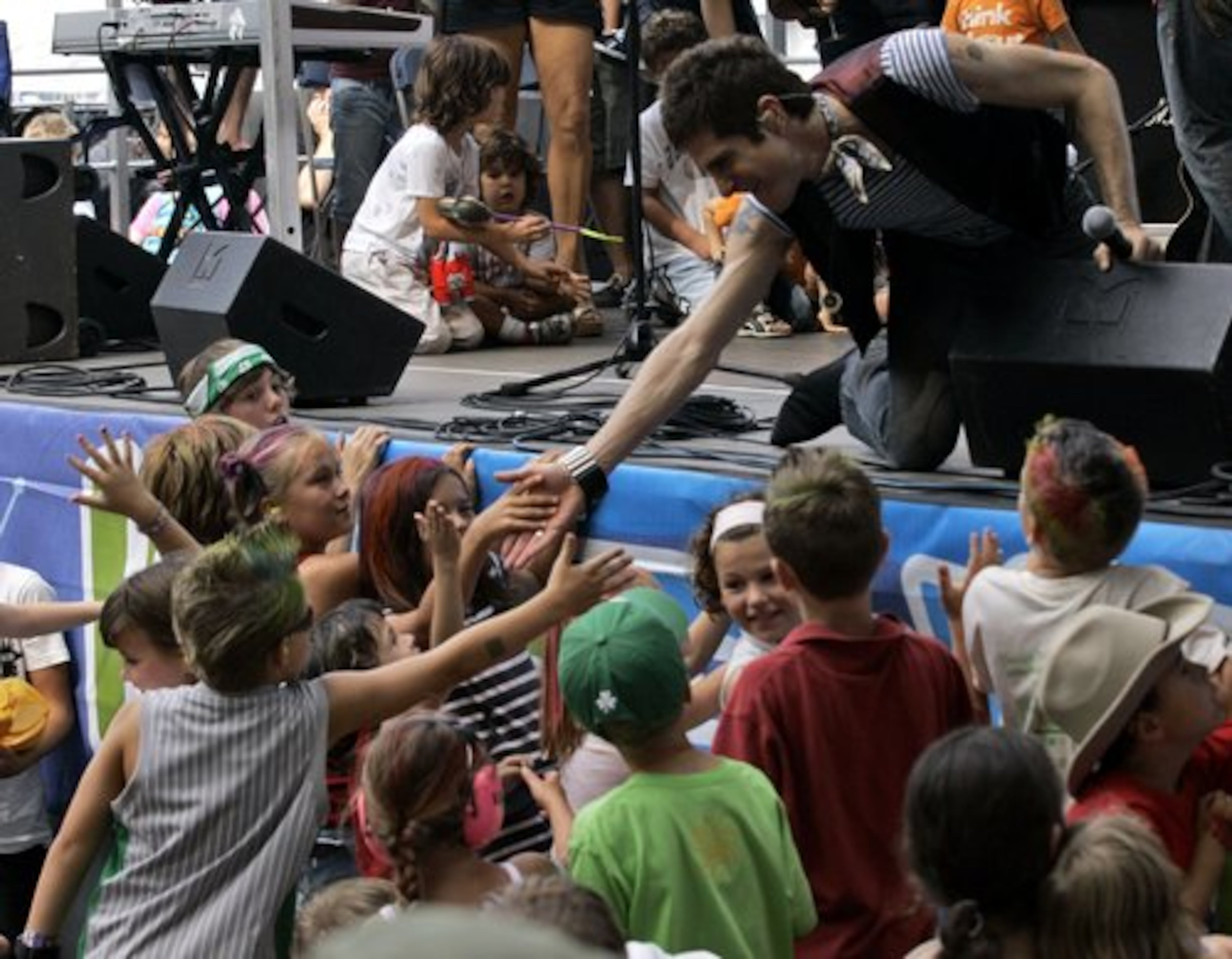 Lollapalooza producer Perry Farrell greets children at the Kidzapalooza stage.