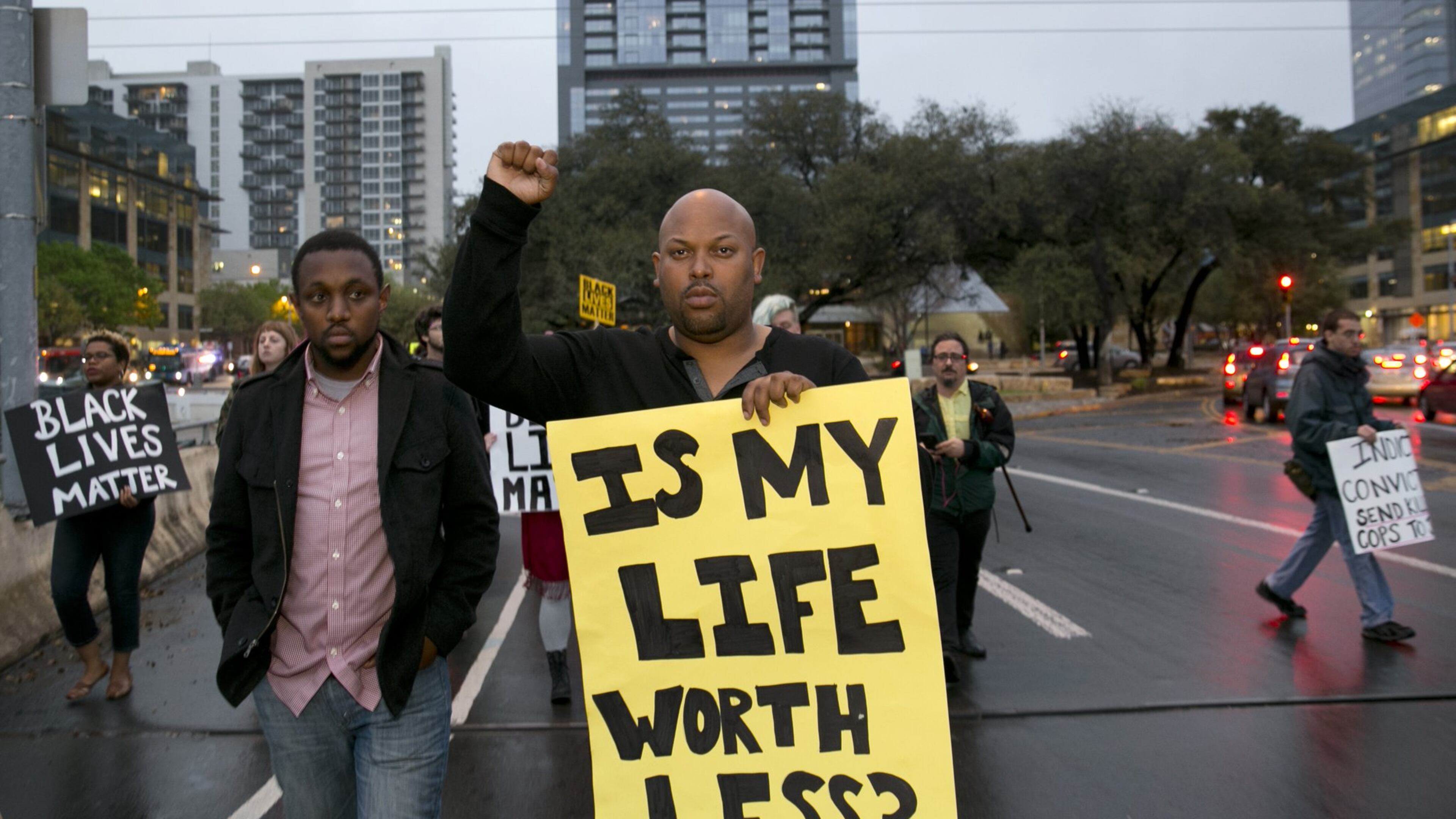 Chas Moore, left, and Ashton P. Woods, march with members of Black Lives Matter from City Hall to the Town Lake Center on Thursday March 10, 2016, to protest the shooting of David Joseph. JAY JANNER / AMERICAN-STATESMAN
