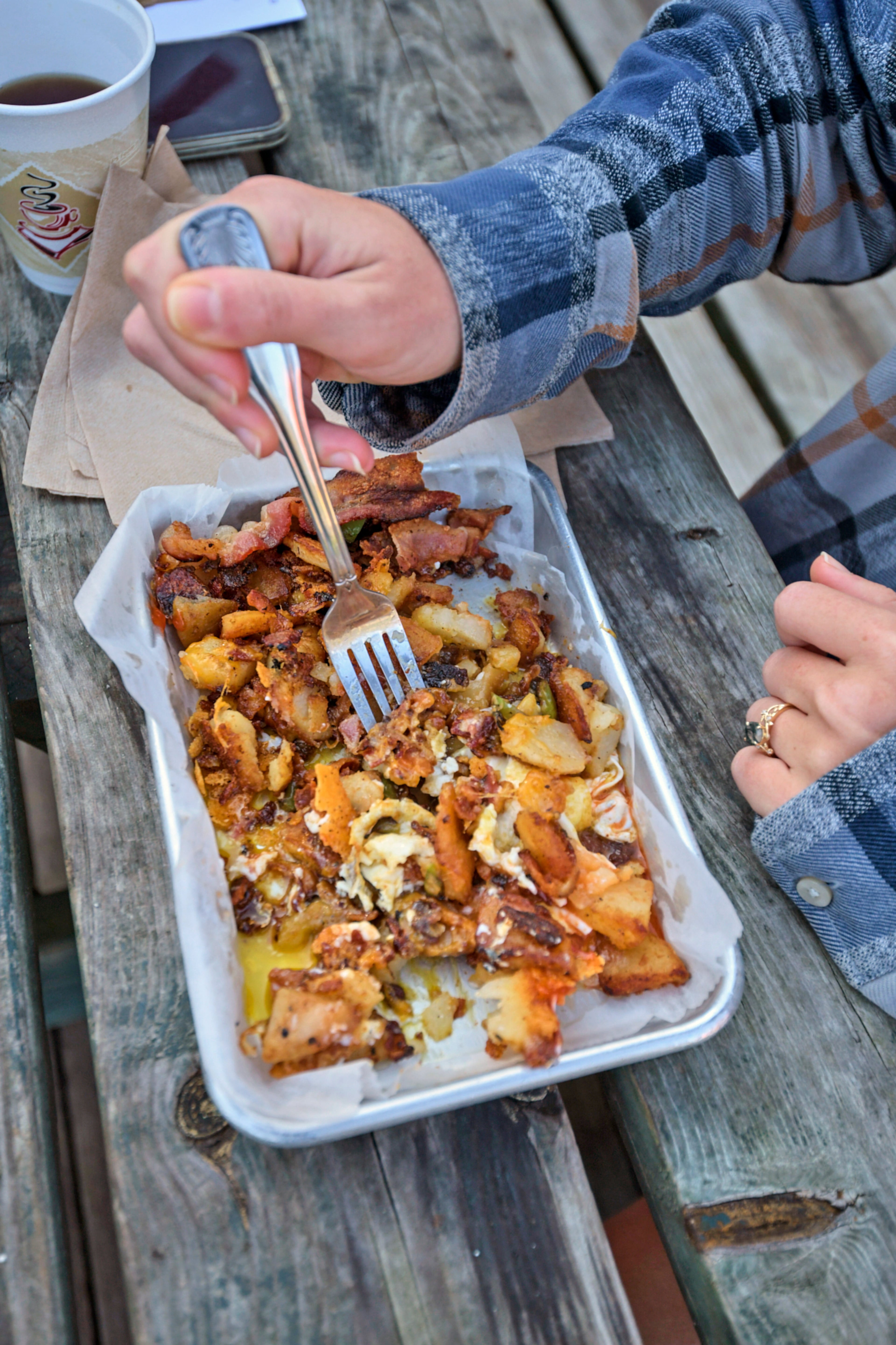 A customer eating a "Hoochee" Platter which consists of home fries, onions, peppers, monterery and cheddar cheese, bacon and eggs at Hoochee's River Basket in Helen, GA
Photo taken on Tuesday October 8th, 2024 by Greg Rannells for The Atlanta Journal Constitution.
Slug: AAJC 120824 dg diners intro.