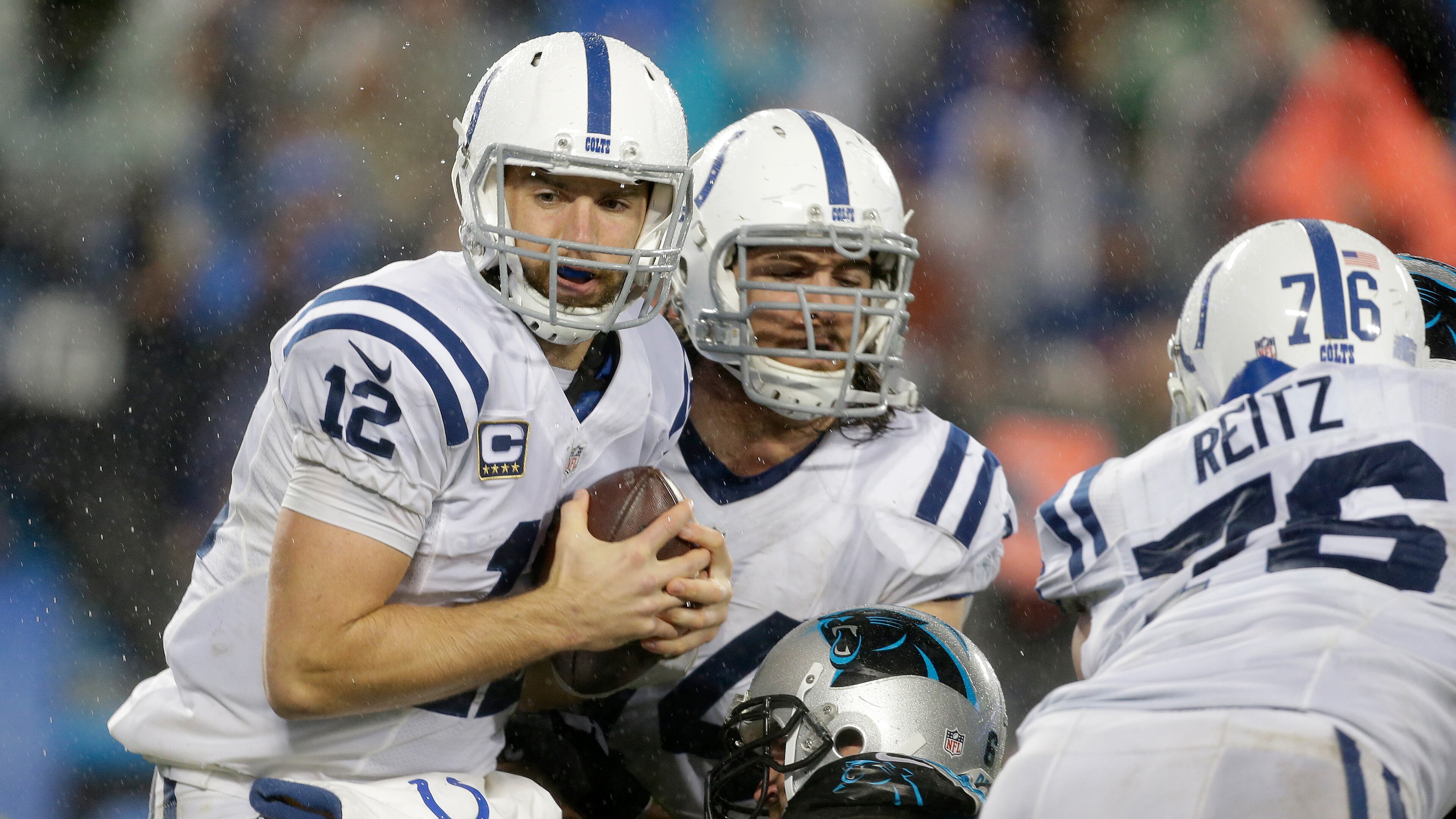 Indianapolis Colts' Andrew Luck (12) protects the football as he is sacked by the Carolina Panthers in the second half of an NFL football game in Charlotte, N.C., Monday, Nov. 2, 2015. The Panthers won in overtime 29-26. (AP Photo/Bob Leverone)