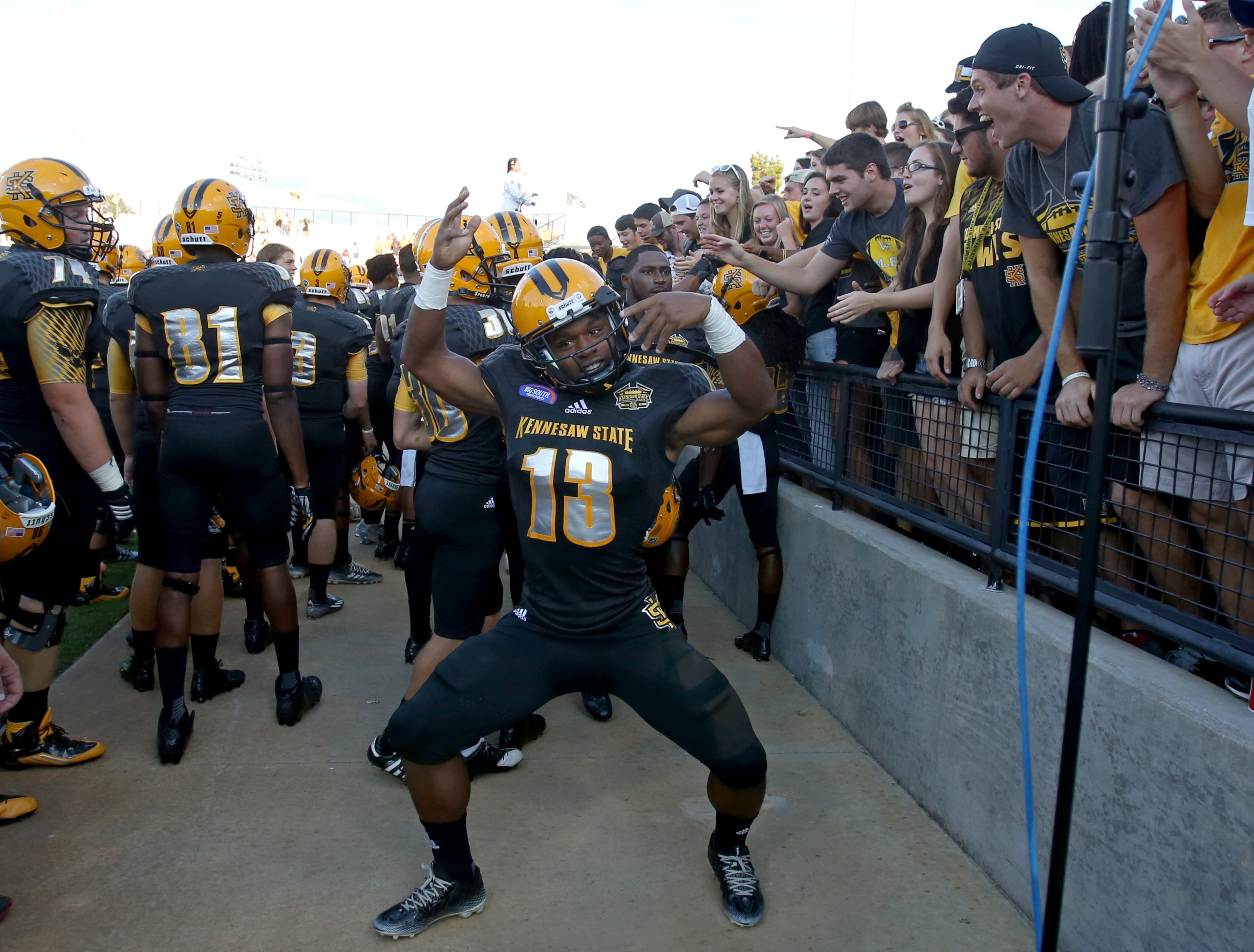 September 12, 2015 - Kennesaw, Ga: Kennesaw State University football running back Ryan Godhigh (13) celebrates with the student section after their win over Edward Waters at Fifth Third Bank Stadium, Saturday, September 12, 2015, in Kennesaw, Ga.. KSU won 58-7. This is the first home game of KSU's inaugural football season. PHOTO / JASON GETZ