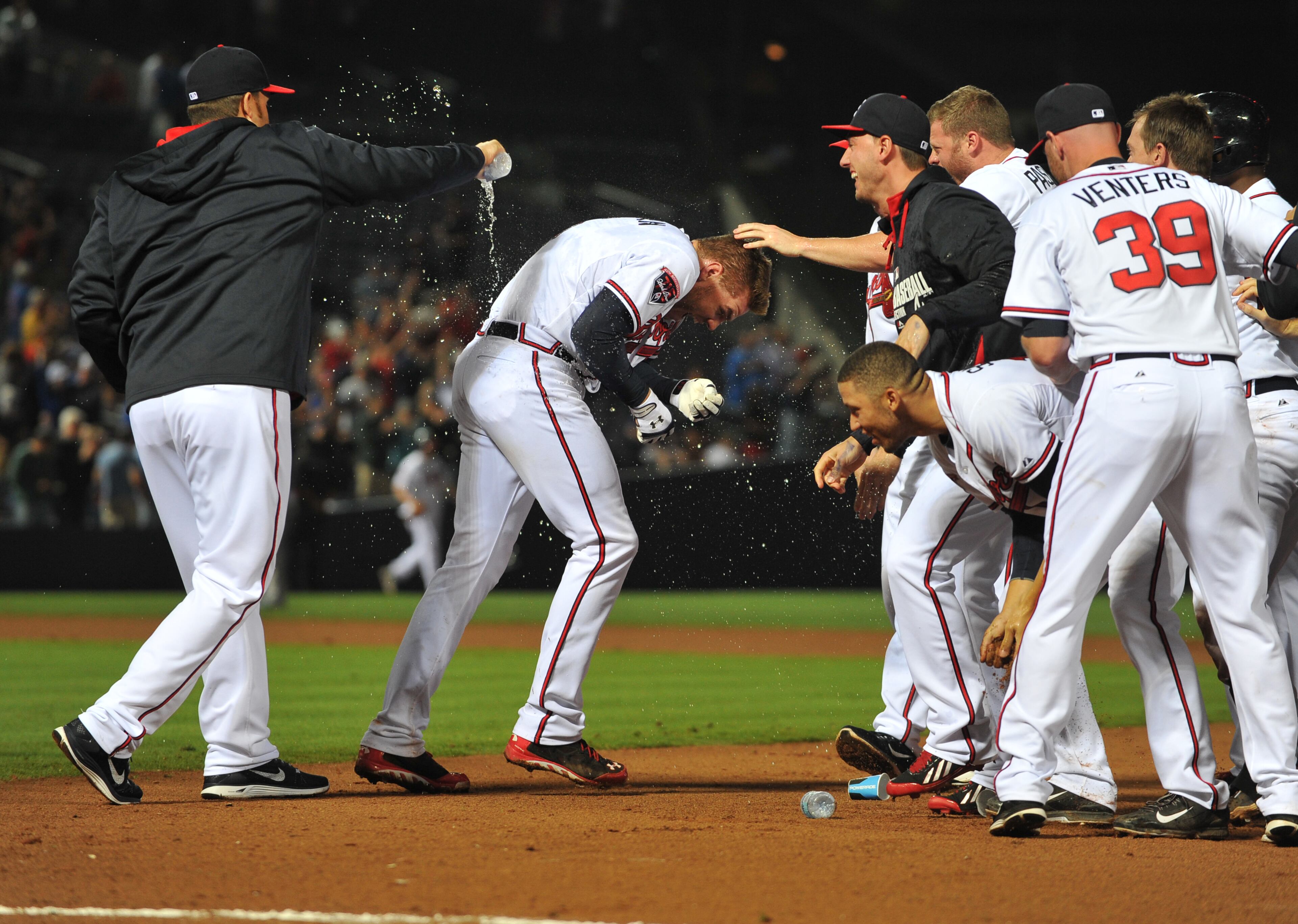 Atlanta Braves Freddie Freeman is doused by teammates following his walk off hit in the 10th inning to give the Braves a 3-2 win over the Chicago Cubs Friday May 9, 2014 at Turner Field.