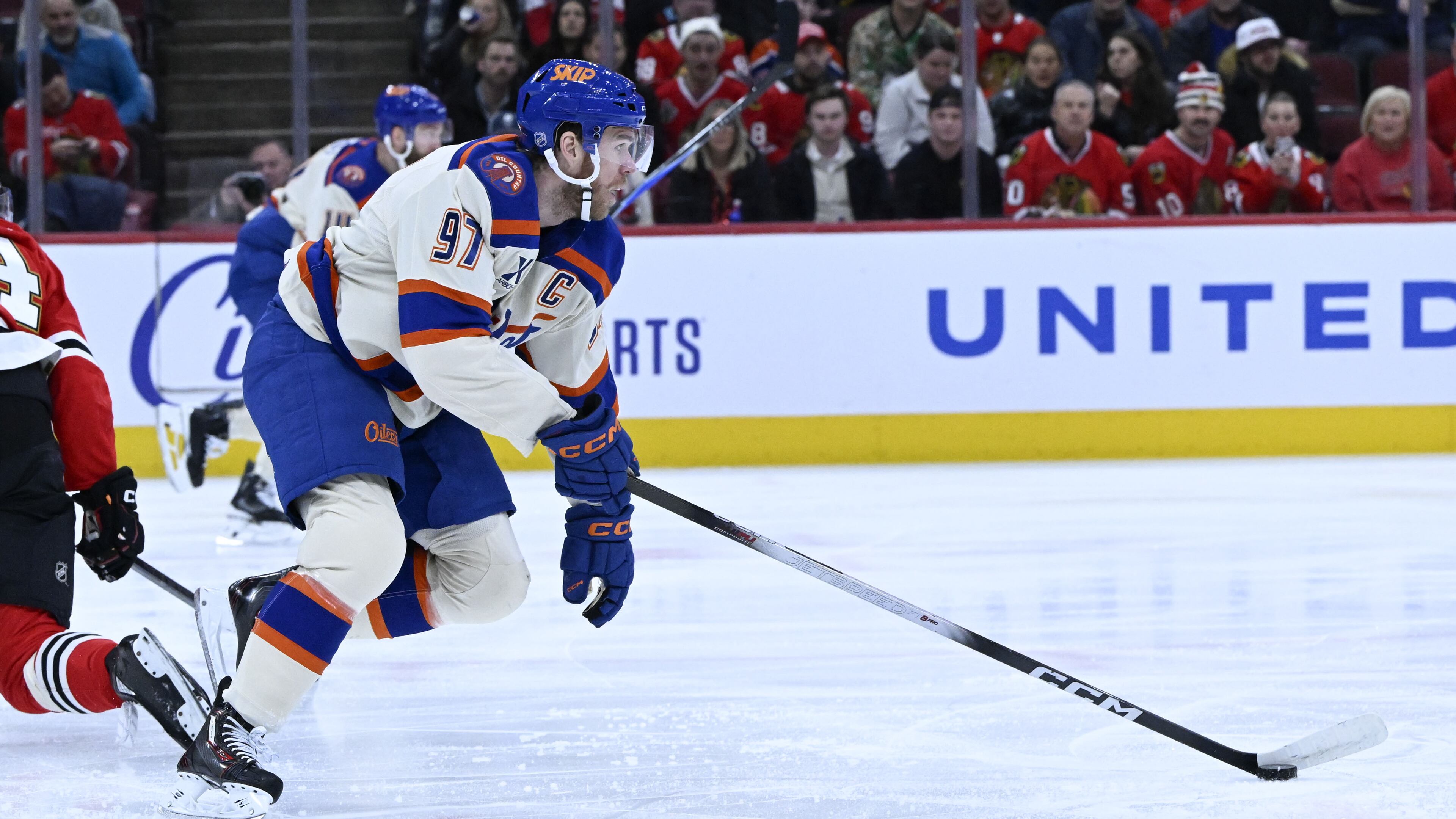 Edmonton Oilers center Connor McDavid (97) moves the puck against the Chicago Blackhawks during the first period of an NHL hockey game, Monday, Jan. 12, 2026, in Chicago. (AP Photo/Matt Marton)