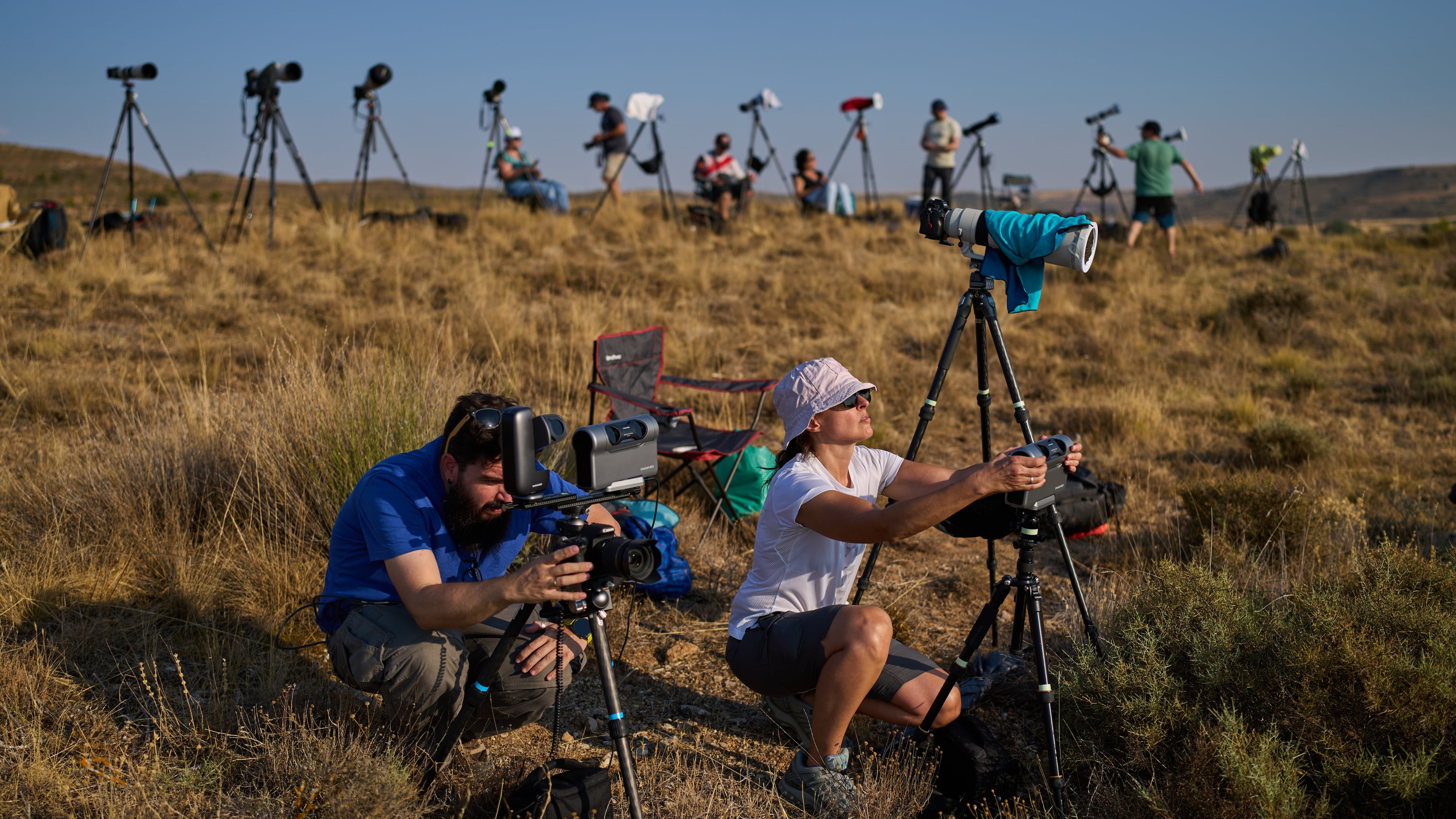 Members of the "Los Taraos" amateur astrophotography group, set up cameras to shoot a total solar eclipse in Berlanga de Duero, central Spain, Wednesday, Aug. 12, 2026. (AP Photo/Bernat Armangue)