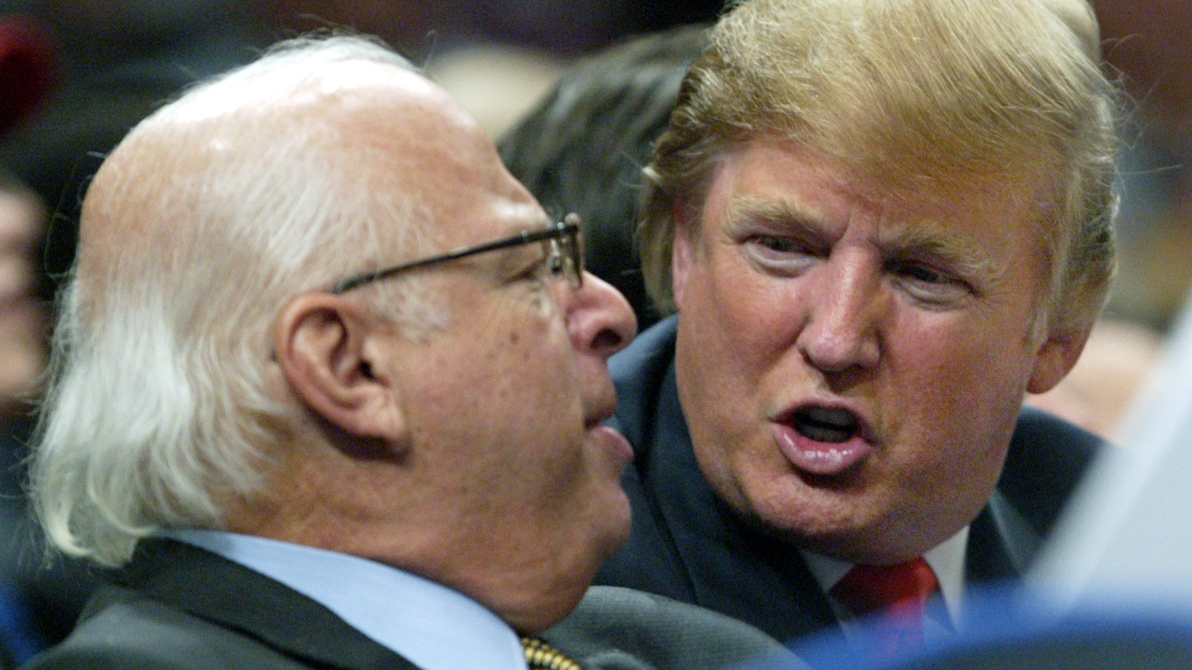 FILE - Donald Trump, right, talks to an unidentified man from the stands at Madison Square Garden during the New York Knicks game against the Dallas Mavericks on Jan. 11, 2006, in New York. (AP Photo/Kathy Willens, File)