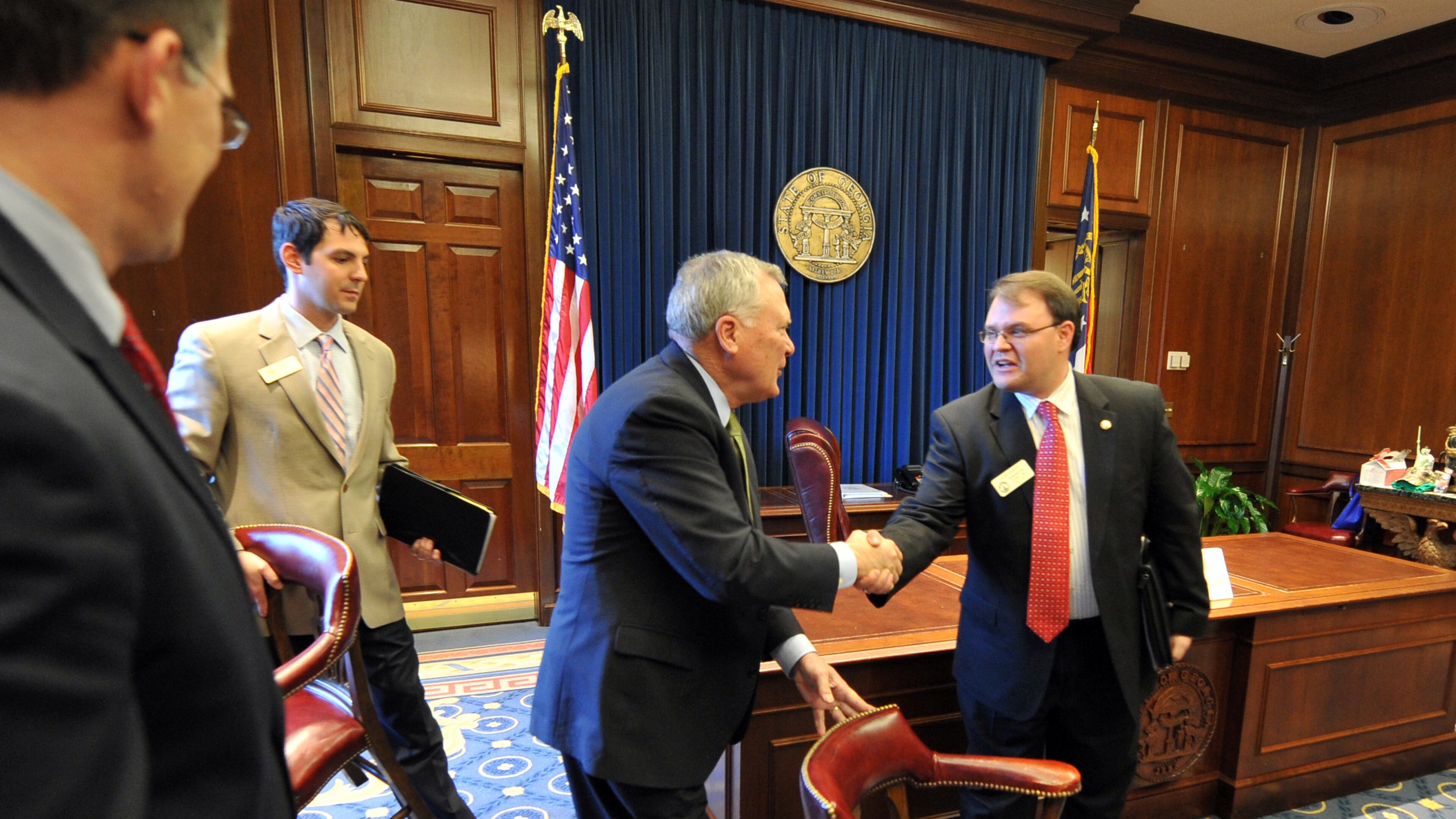 Gov. Nathan Deal greets state Rep. Jason Spencer, R-Woodbine, before meeting with local officials in Spencer’s district in Camden County in 2011. Brant Sanderlin / bsanderlin@ajc.com