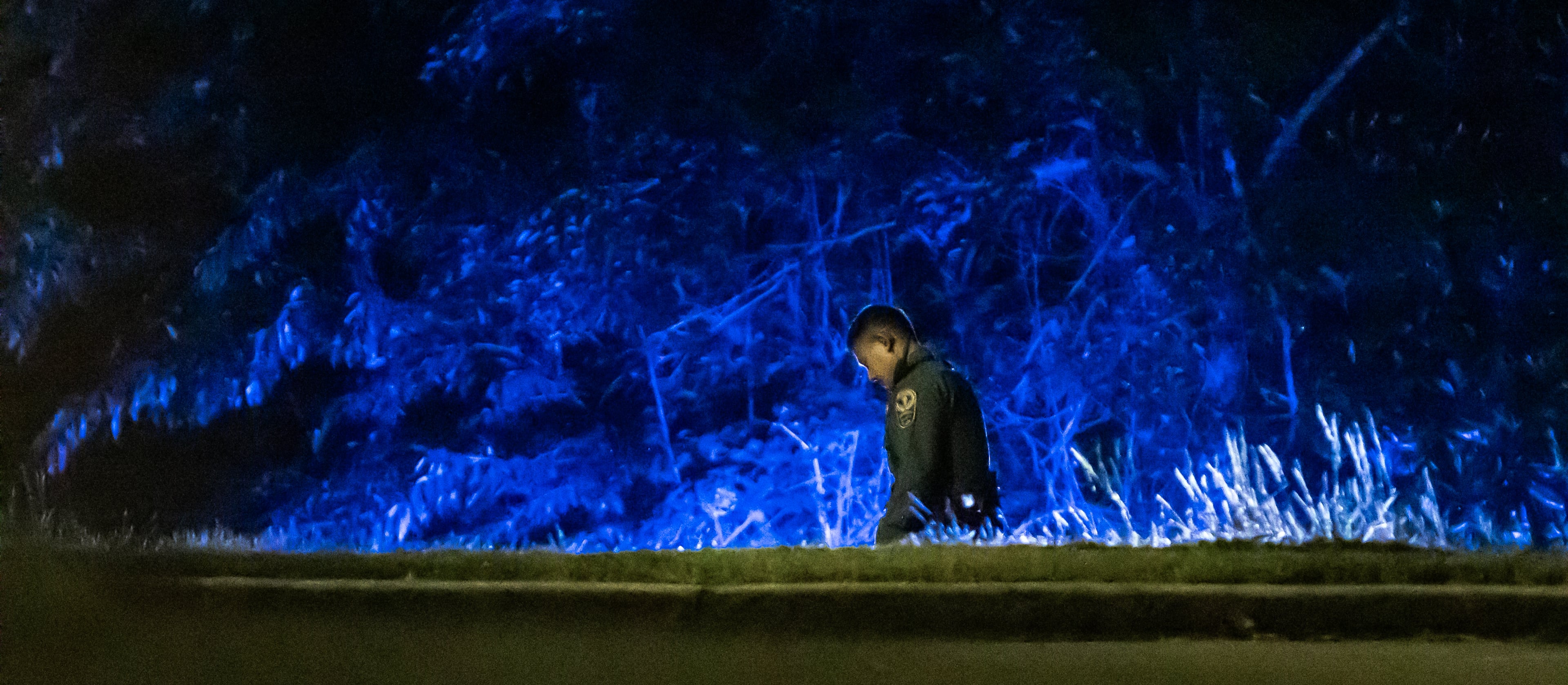 Investigators examine the scene of a shooting, where a man and three children shot to death inside a car at Lucky Shoals Park outside of Tucker on Wednesday, May 8, 2024. The man was in the driver’s seat. He, a boy and two girls all appeared to have been shot. Their names and ages were not released, but authorities said the children appeared to have been in elementary and middle school. (John Spink/AJC)
