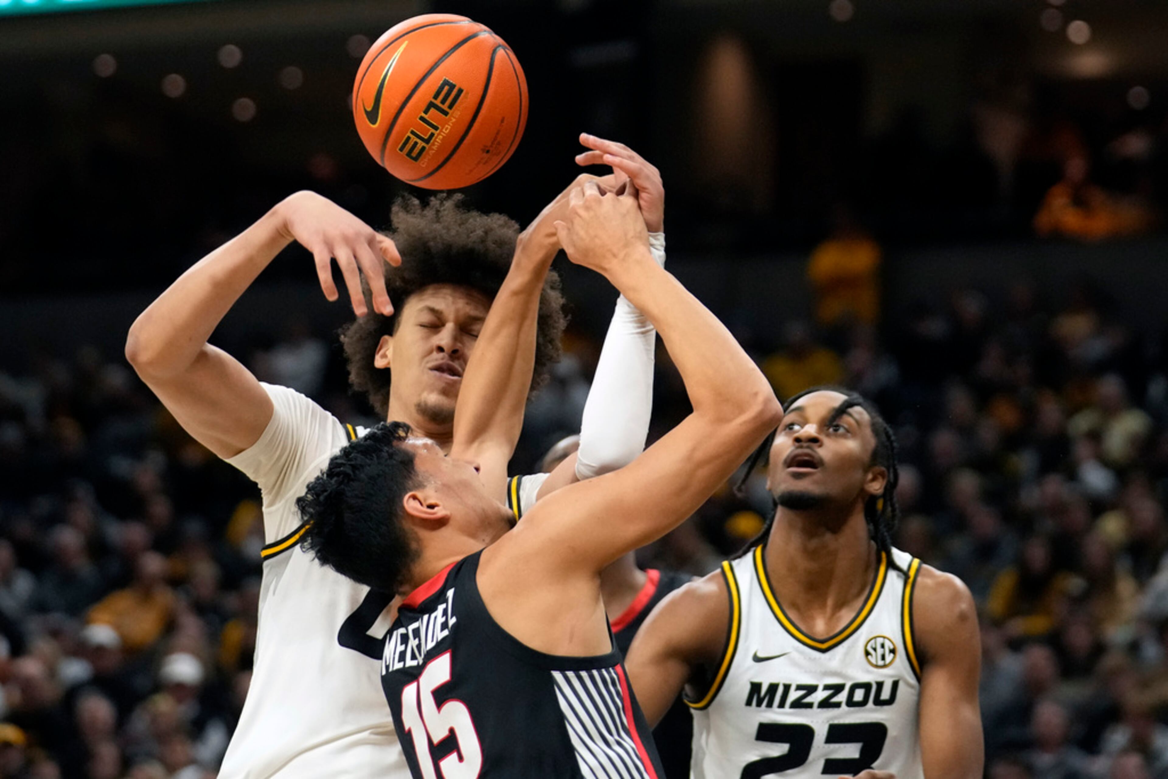 Georgia's RJ Melendez (15) looses control of the ball as Missouri's Jordan Butler and Aidan Shaw, right, defend during the first half of an NCAA college basketball game Saturday, Jan. 6, 2024, in Columbia, Mo. (AP Photo/Jeff Roberson)