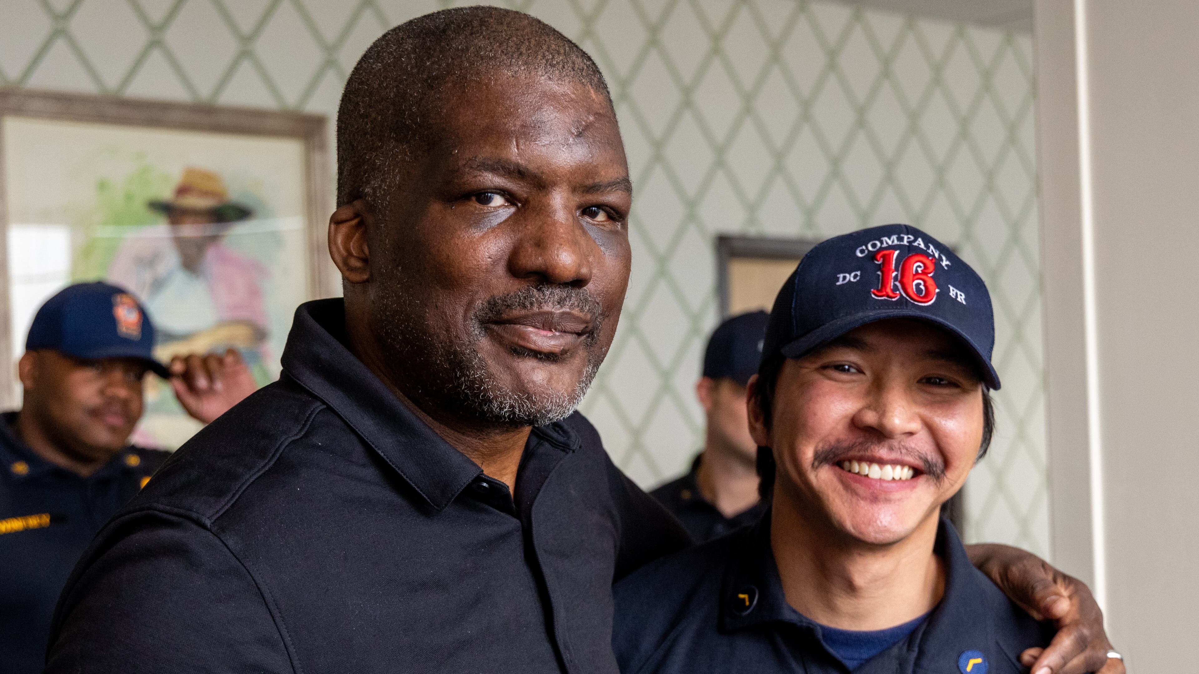 Portrait of Fulton County Fire Department Lieutenant Mark Quick (left) stands with Nishan Mu, the DeKalb County Fire Rescue member that helped save his life. PHIL SKINNER FOR THE ATLANTA JOURNAL-CONSTITUTION