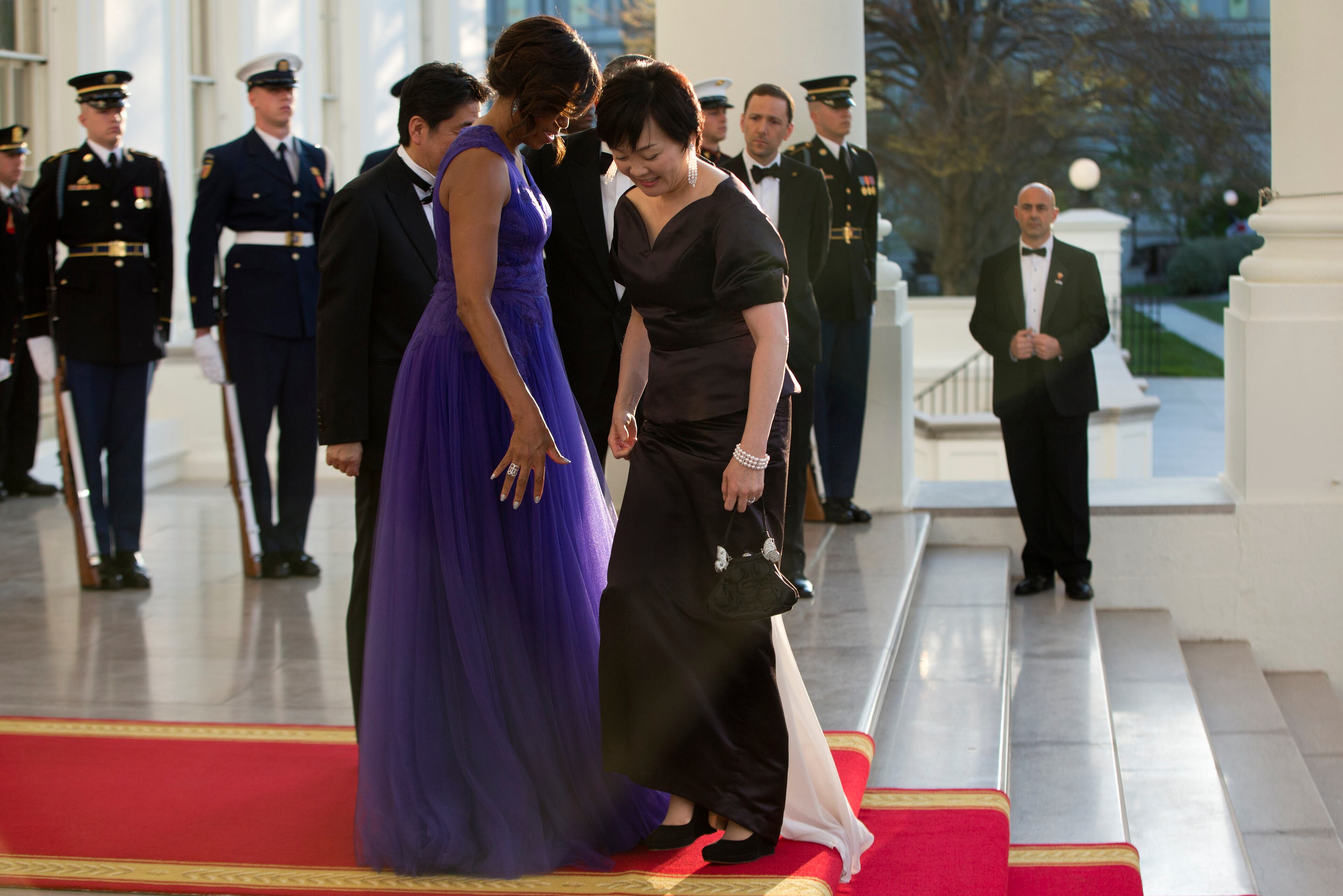 First lady Michelle Obama greets Akie Abe, the wife of Japanese Prime Minister Shinzo Abe, at the North Portico of the White House as she arrives with her husband for a state dinner, Tuesday, April 28, 2015, in Washington. (AP Photo/Pablo Martinez Monsivais)