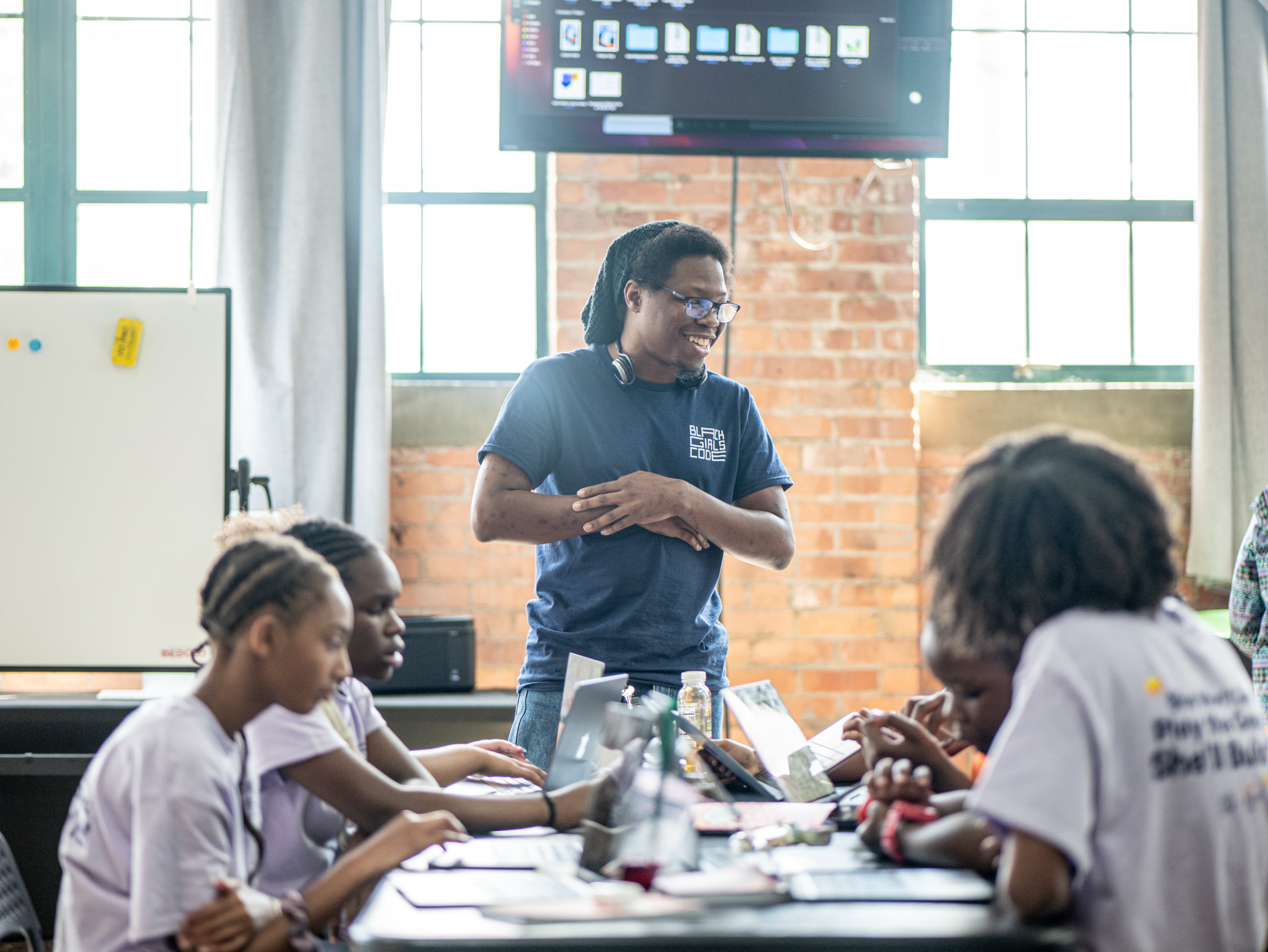 A Black Girls Code camp instructor teaches girls how to program their own game using GDScript, a coding language similar to Python. (Courtesy of Black Girls Code)
