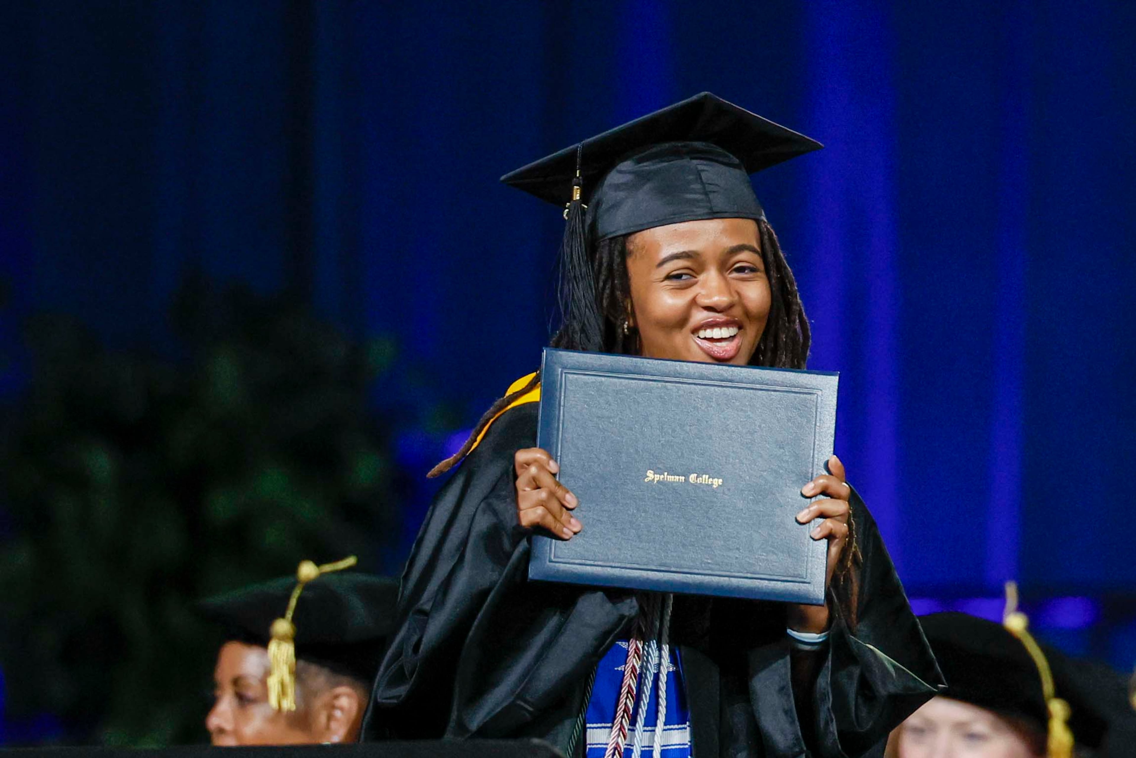 A graduate reacts after receiving her diploma during the Spelman College Commencement at the Georgia International Convention Center in College Park on Sunday, May 17, 2026. (Miguel Martinez/AJC)