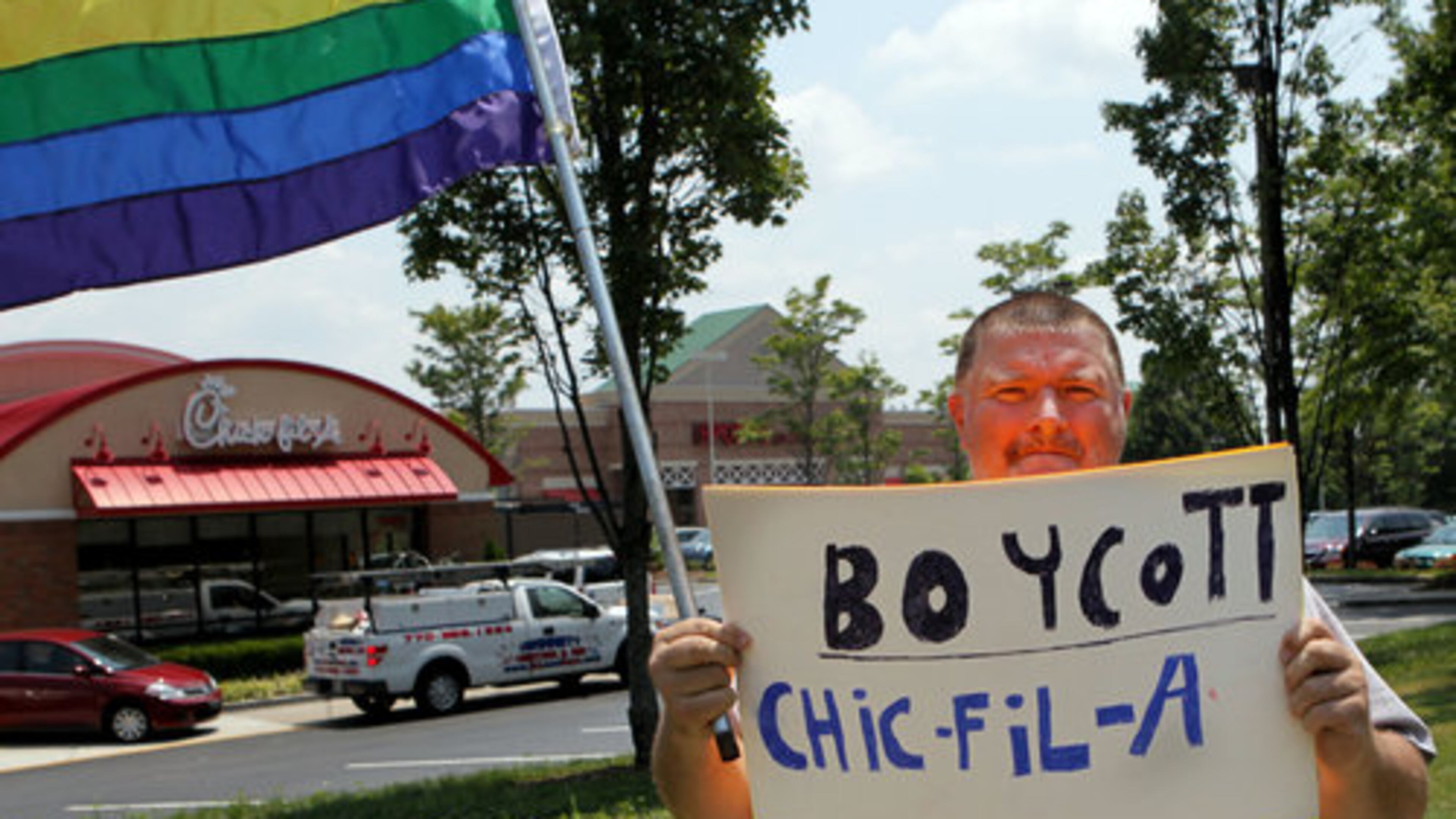 August 1, 2012 - Lone protestor Dwayne Tatum marches in front of fans as they jam the Chick-fil-A in Sandy Springs on Mount Vernon Highway on Wednesday August 1st, 2012 to show their support for company president Dan Cathy's stand on gay marriage. Chick-fil-A Appreciation Day is the brainchild of former Arkansas governor and presidential candidate Mike Huckabee. Cathy told an online Christian news outlet in mid-July that he is "guilty as charged" for supporting marriage as traditionally defined. Huckabee says the ensuing firestorm over that remark, including calls for boycotts and blocking Chick-fil-A stores in two cities, shows intolerance for folks with a different view than supporters of gay marriage and he wants to show the company it has support.