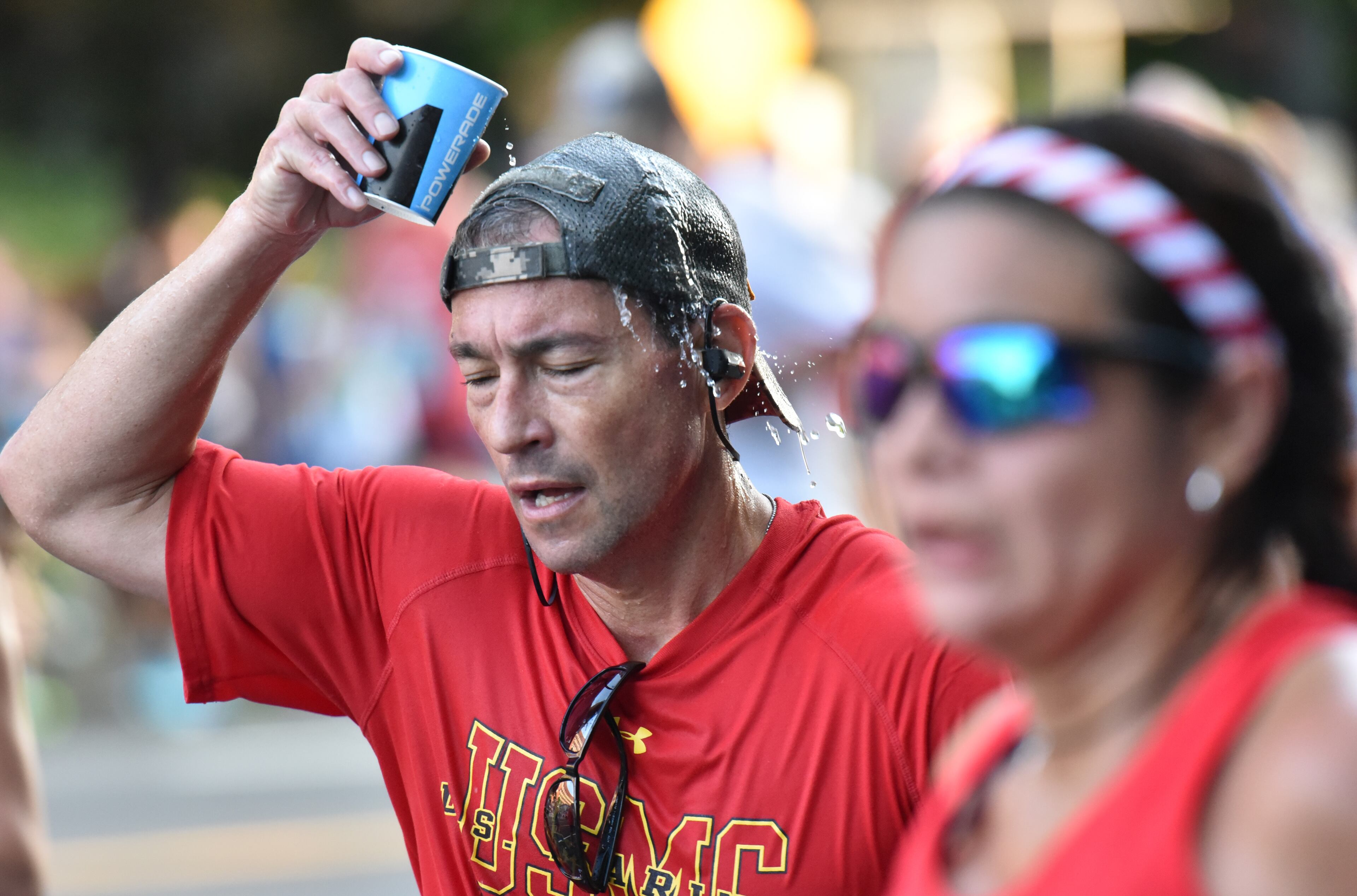 July 4, 2018 Atlanta - Runners cool off at a water station on the top of Cardiac Hill during the AJC Peachtree Road Race on Wednesday, July 4, 2018. HYOSUB SHIN / HSHIN@AJC.COM