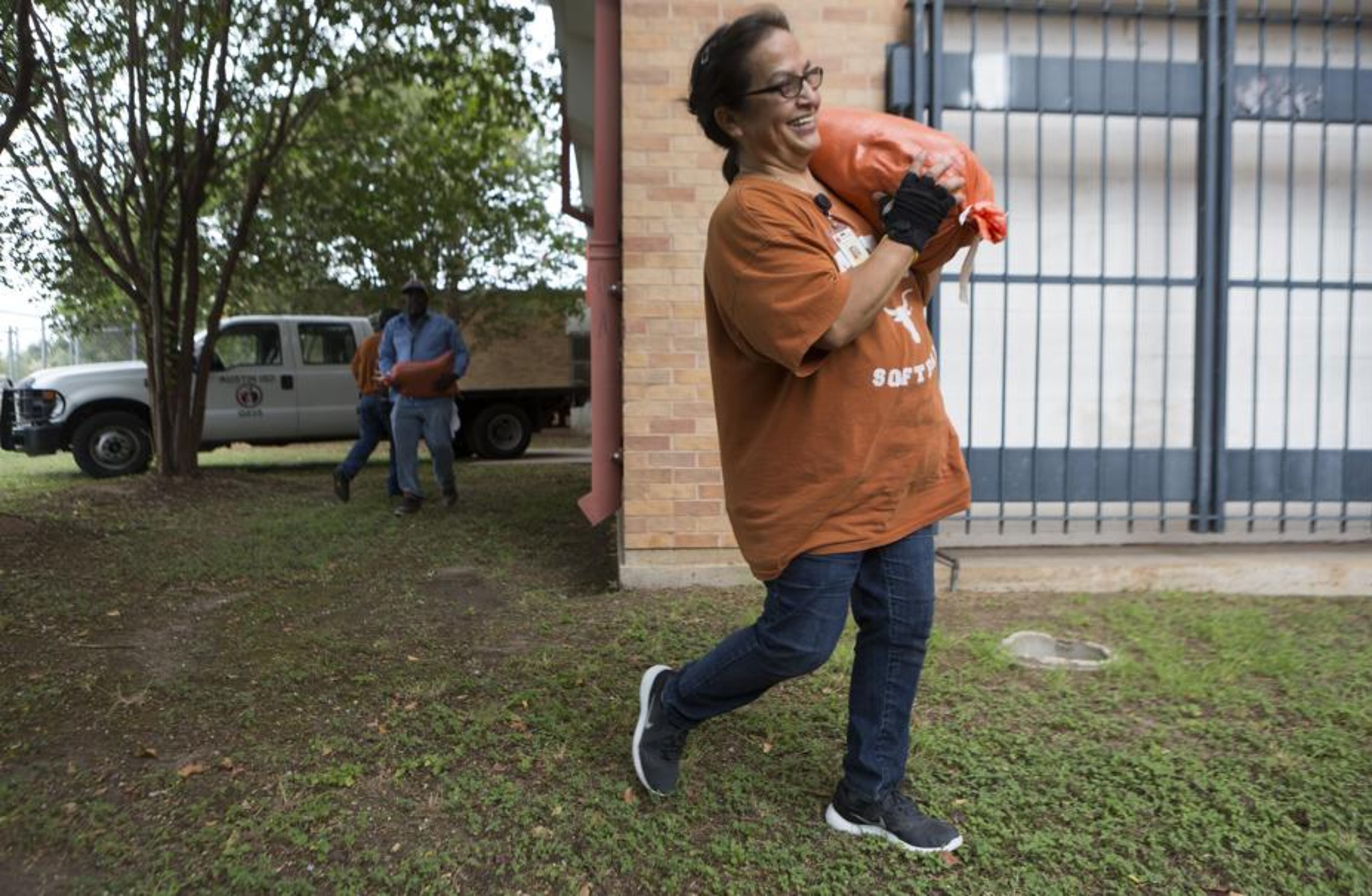 Austin Independent School District employee Leticia Hernandez places sandbags around Martin Middle School as the city prepares for Hurricane Harvey Friday, Aug. 25, 2017.