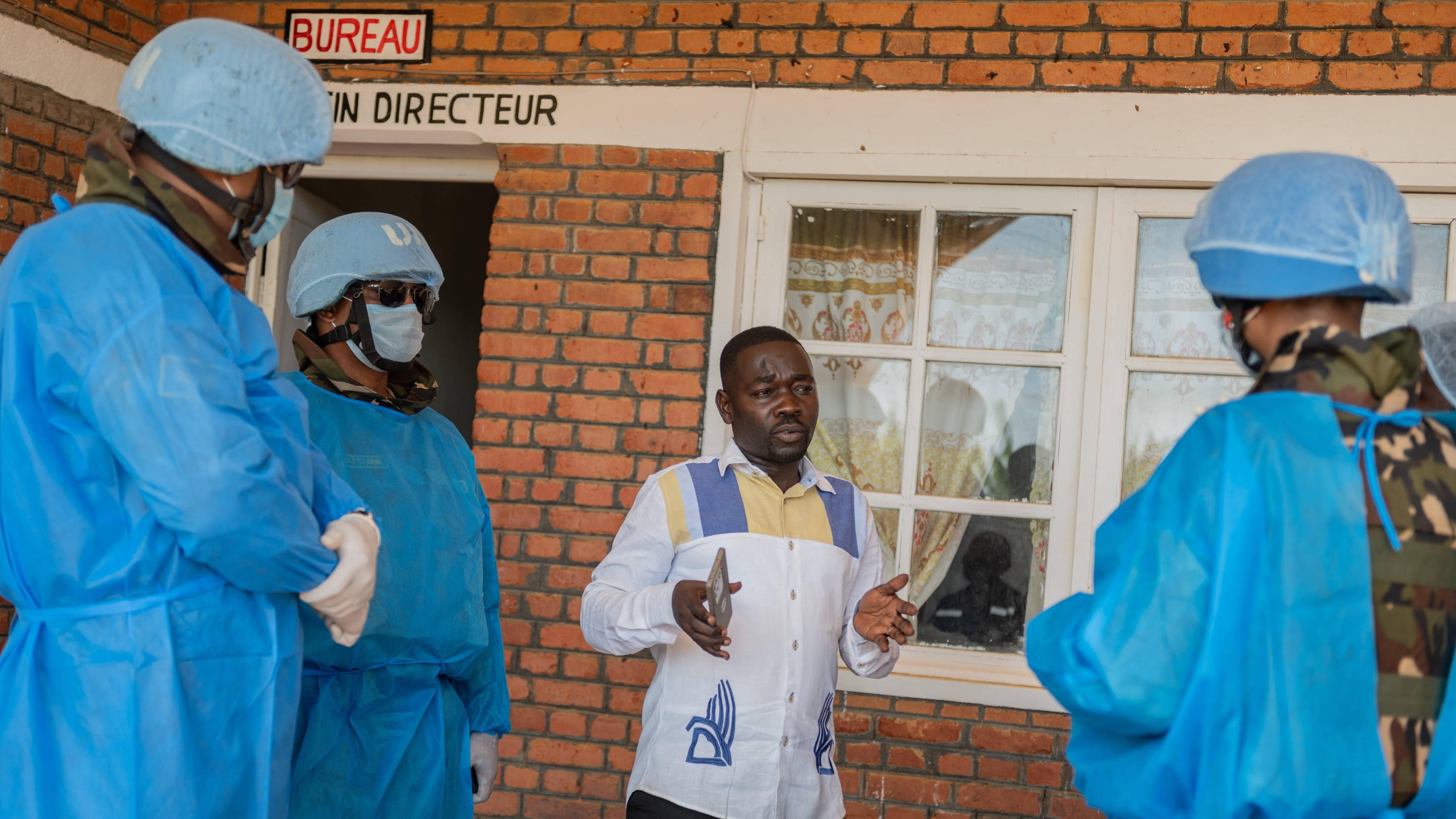 Richard Lokudu, center, the medical director of Mongbwalu General Hospital, speaks with UN peacekeepers in Mongbwalu, Congo, Friday, June 5, 2026. (AP Photo/Moses Sawasawa)