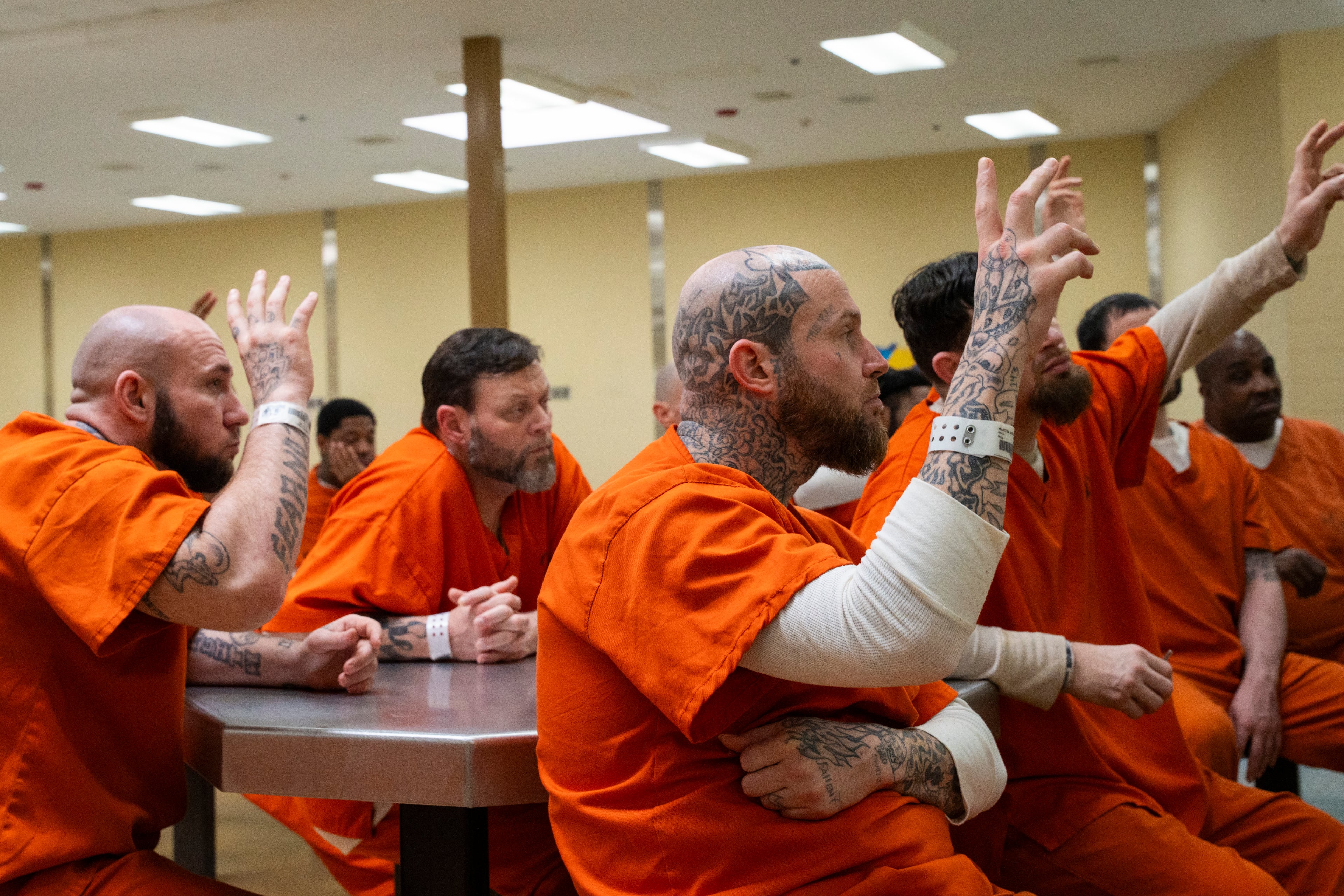 Inmates listen intently as Shane Sims guides a discussion in the Athens-Clarke County Jail. Sims helped design the Re-Entry Success Jail Resident Program. (Olivia Bowdoin for the AJC)