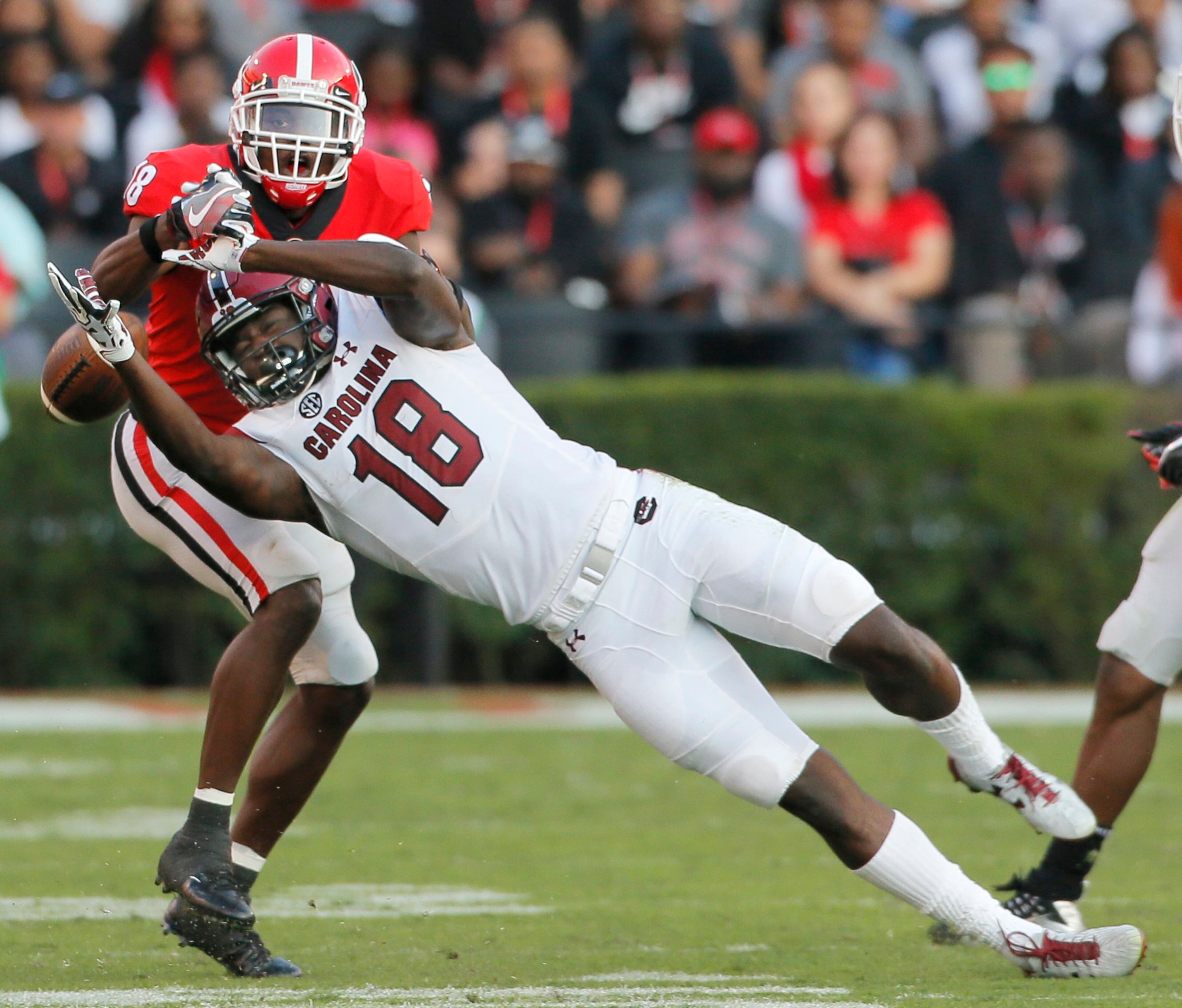11/4/17 - Athens - Georgia Bulldogs defensive back Deandre Baker (18) breaks up third down pass intended for South Carolina Gamecocks wide receiver OrTre Smith (18). NCAA football game between the University of Georgia Bulldogs and the University of South Carolina Gamecocks BOB ANDRES /BANDRES@AJC.COM