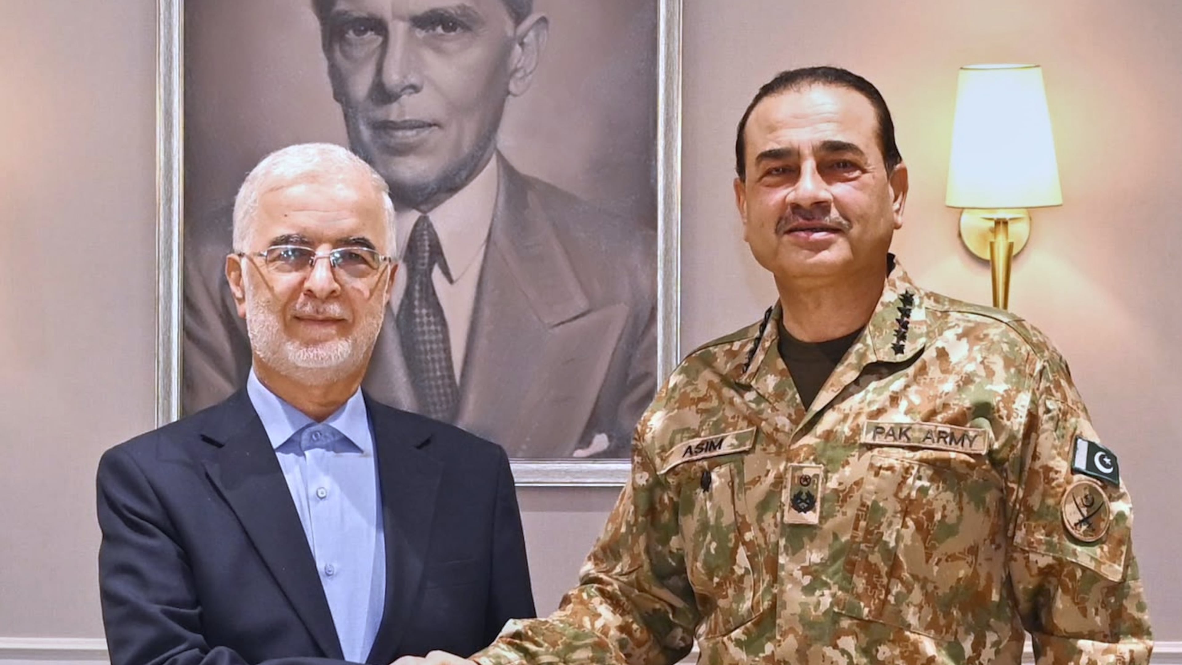 In this photo released by the Inter Services Public Relations, Iran's Interior Minister Eskandar Momeni, left, shakes hand with Pakistan's Army Chief Field Marshal Asim Munir prior to their meeting in Rawalpindi, Pakistan, Tuesday, July 21, 2026. (Inter Services Public Relations via AP)