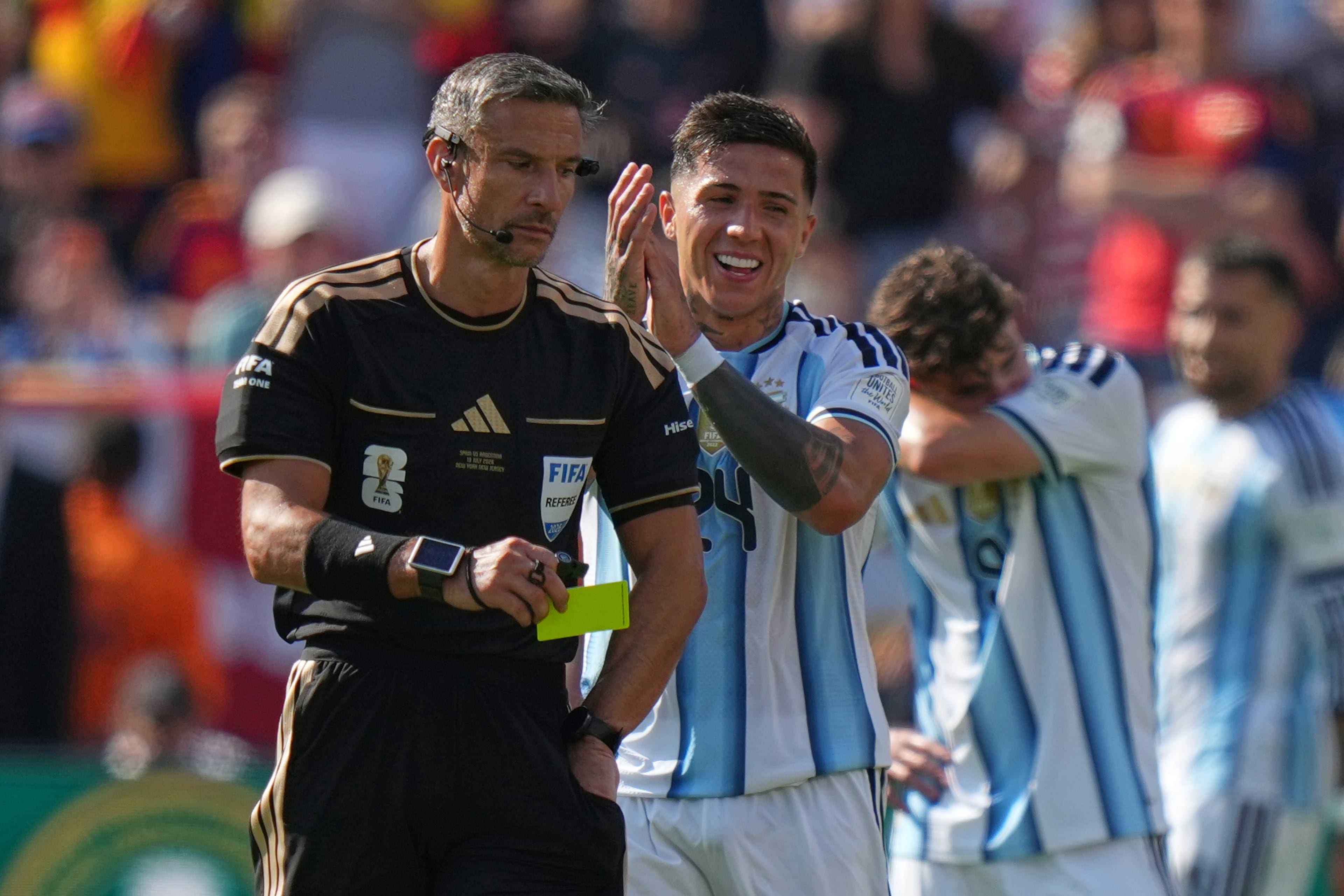 Argentina's Enzo Fernandez (second from left) applauds Referee Slavko Vincic of Slovenia after receiving a yellow card during the World Cup final soccer match between Spain and Argentina in East Rutherford, N.J., near New York, Sunday, July 19, 2026. (Stephanie Scarbrough/AP)