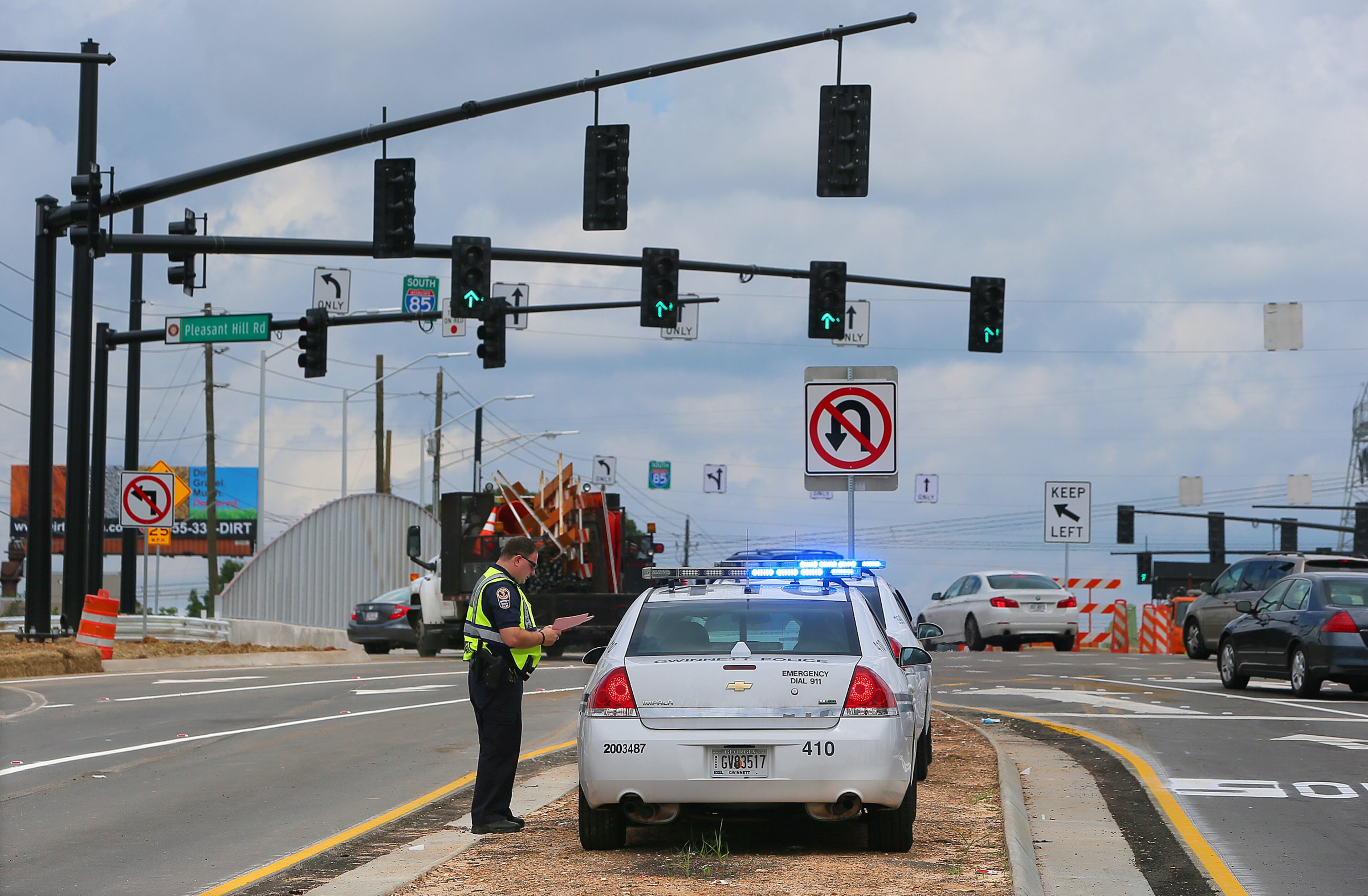Gwinnett County police help make sure everything is operating correctly and safely as Pleasant Hill Road's new "diverging diamond" interchange opens at noon on June 9, 2013, in Duluth.