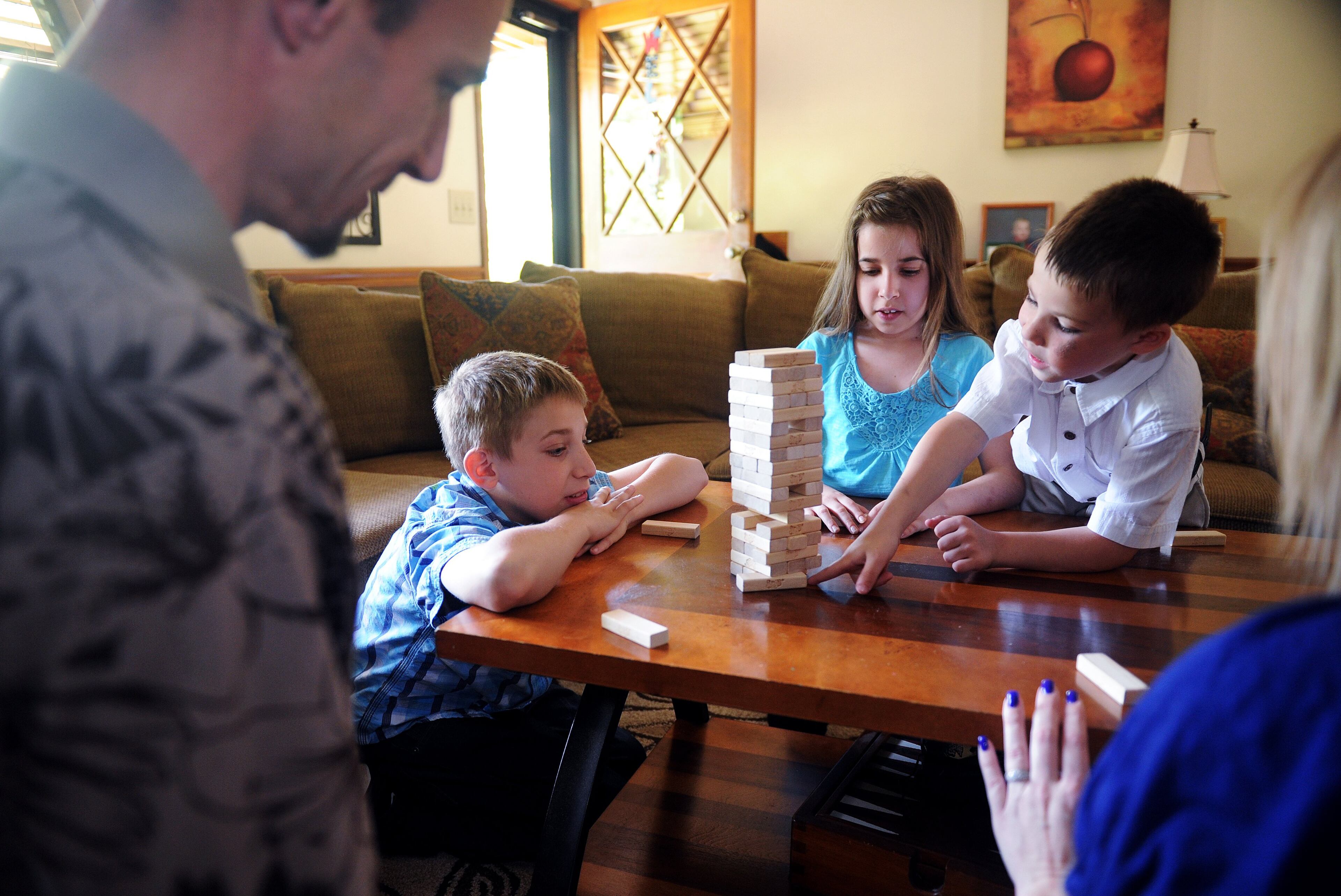 Joe Dickman (left) and his wife Lori (right) play Jenga with their children (from left) Bryson, 11, Sarah, 12, and Logan, 6, at their Acworth home Sunday, April 29, 2012.
