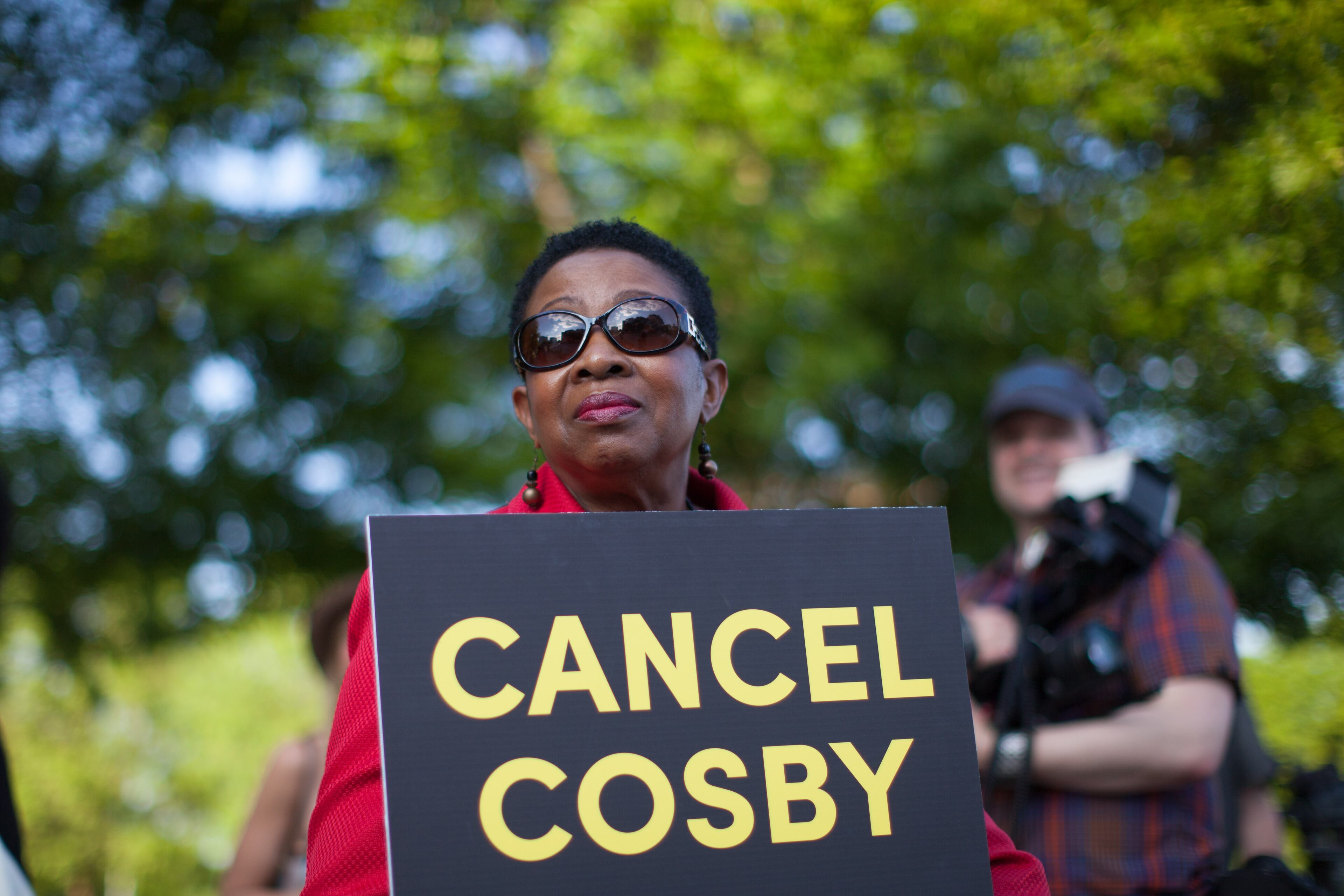 A woman holds a sign during a protest against Bill Cosby's performance at the Cobb Energy Performing Arts Centre, Saturday, May 2, 2015, in Atlanta, Ga. A group of protesters gathered to speak out against Cosby's performance after allegations that he sexually assaulted several women throughout his career. (SPECIAL/BRANDEN CAMP)