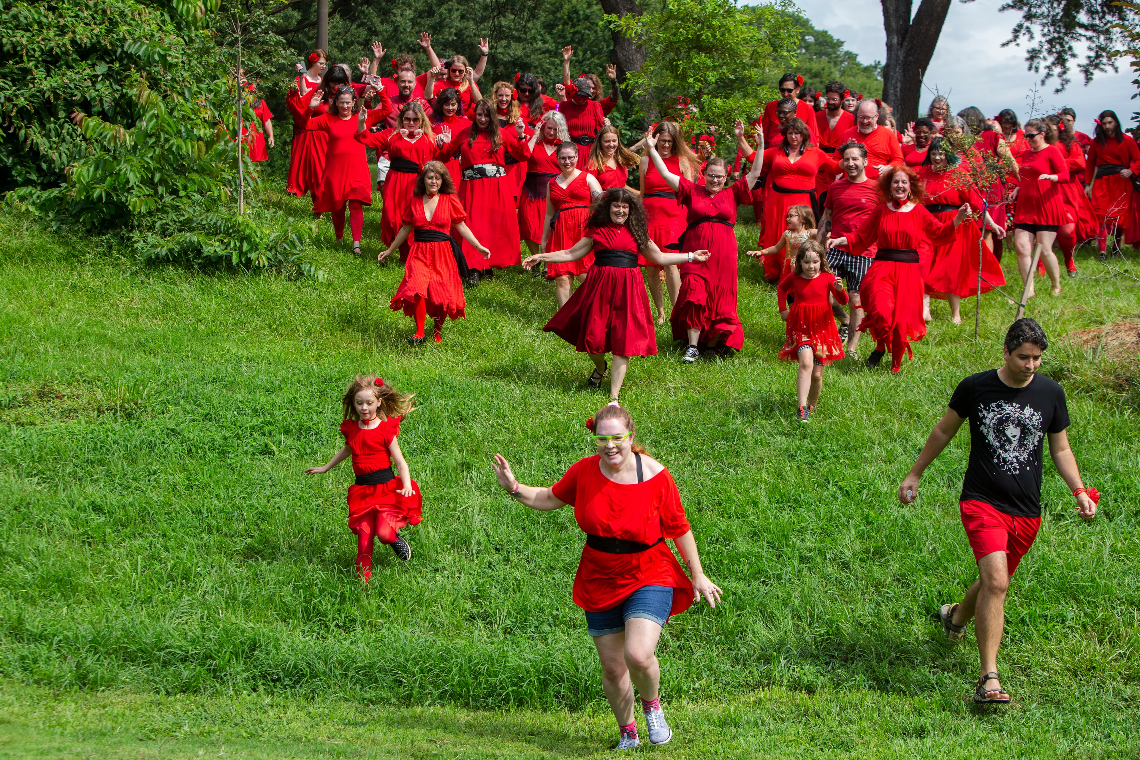 Kate Bush fans running down the hill after a group dance performance to celebrate the seventh annual international "Most Wuthering Heights Day Ever," on Saturday, July 30, 2022, in Candler Park in Atlanta. The event celebrates Kate Bush's 1978 song "Wuthering Heights" with events in more than 40 cities around the world. CHRISTINA MATACOTTA FOR THE ATLANTA JOURNAL-CONSTITUTION