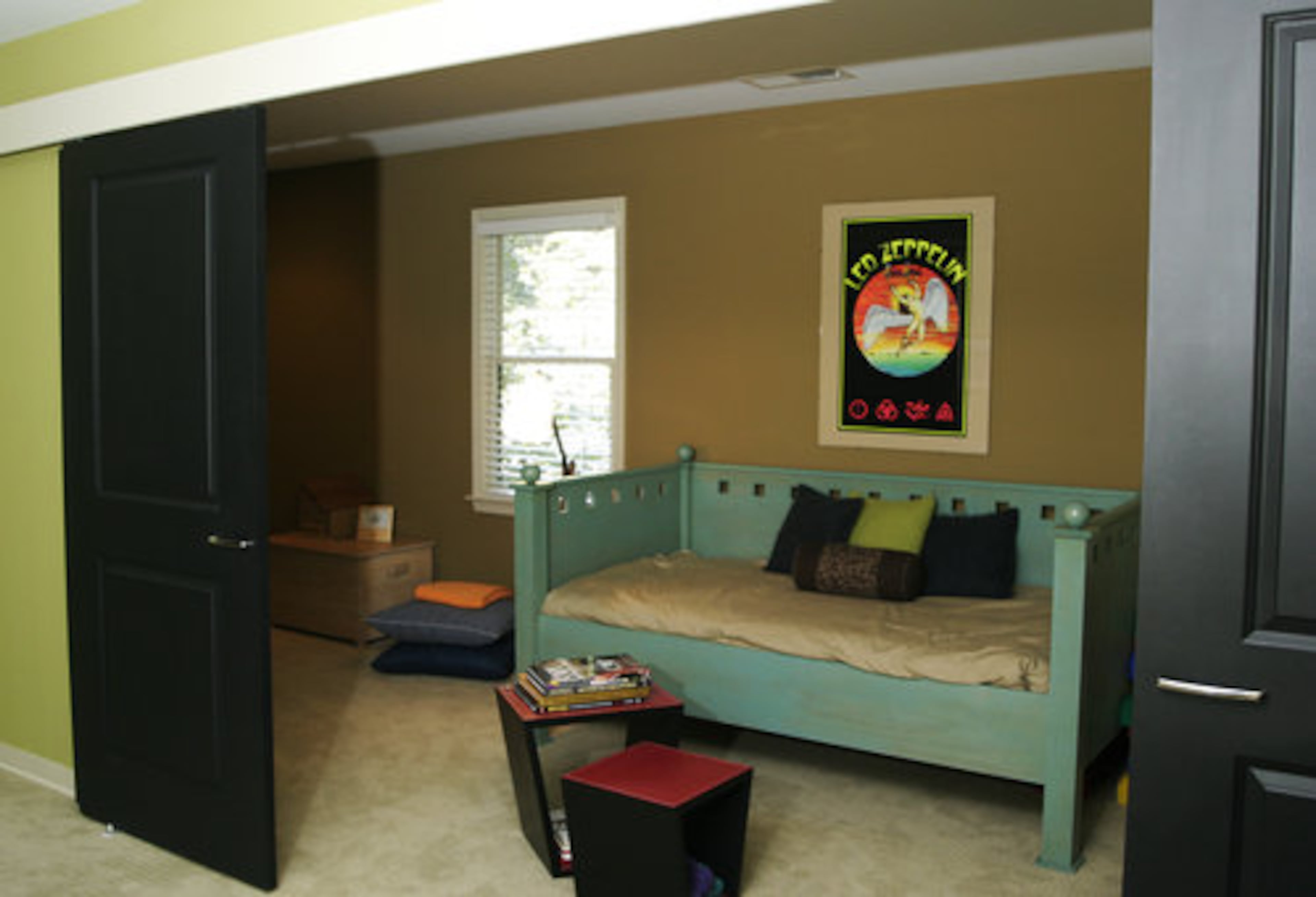 Tyler's room includes a retro Led Zeppelin print and becomes two rooms when the folding doors are shut.