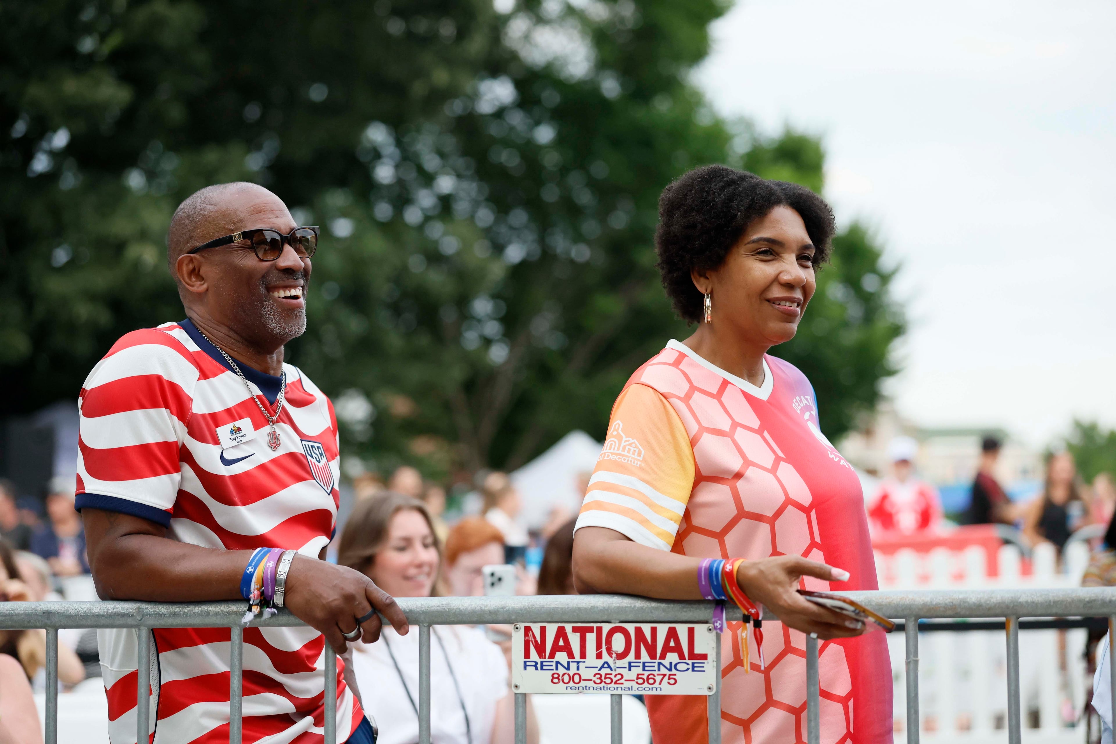 Decatur Mayor Tony Powers and his girlfriend, Dr. Latonia Jennings, listen to Jason Carter, grandson of former President Jimmy Carter, as he introduces the War and Treaty at Decatur WatchFest ’26 on Thursday, June 25, 2026. (Miguel Martinez/AJC)