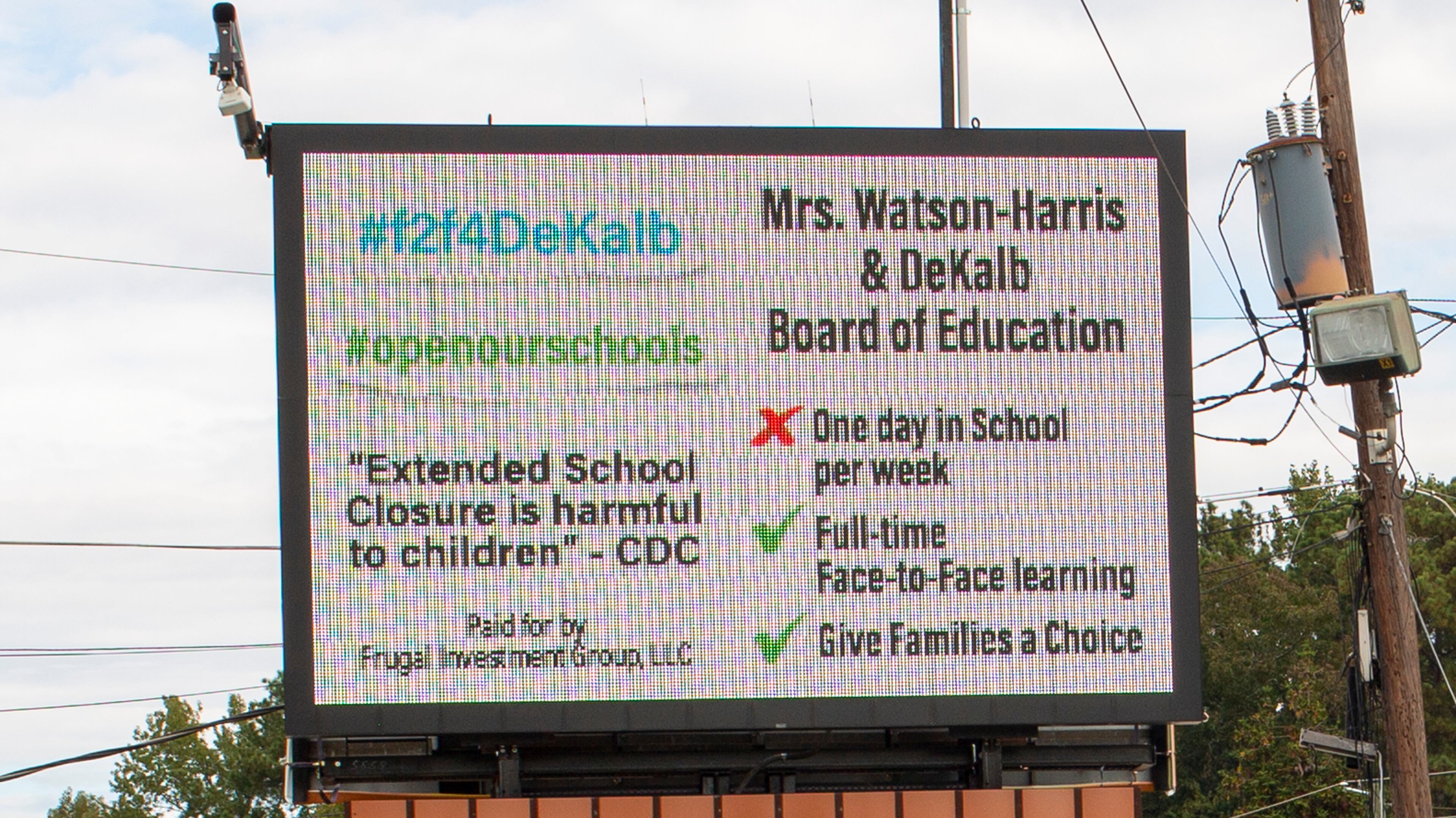 A billboard calling on DeKalb school distict leaders to offer a more robust in-person learning option, paid for by a group of DeKalb County parents, is seen on DeKalb Industrial Way in Decatur, Georgia, on Oct. 16, 2020. (Rebecca Wright for the Atlanta Journal-Constitution)