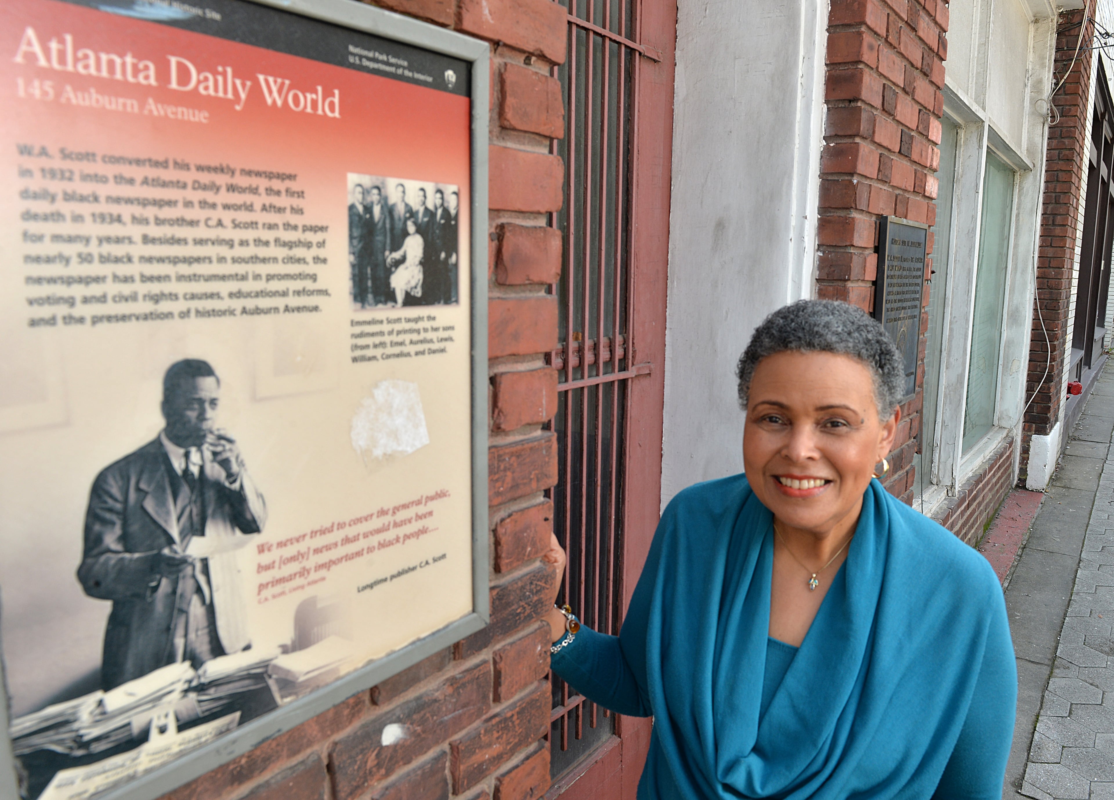 Alexis Scott stands outside of the old abandoned Atlanta Daily World building on Auburn Avenue in Atlanta on March 12, 2014. The Atlanta Daily World, for decades a cornerstone of the city's African American culture, no longer employs any local reporters. The newspaper was sold two years ago this month to out-of-town interests by the founding Scott family. HYOSUB SHIN / HSHIN@AJC.COM