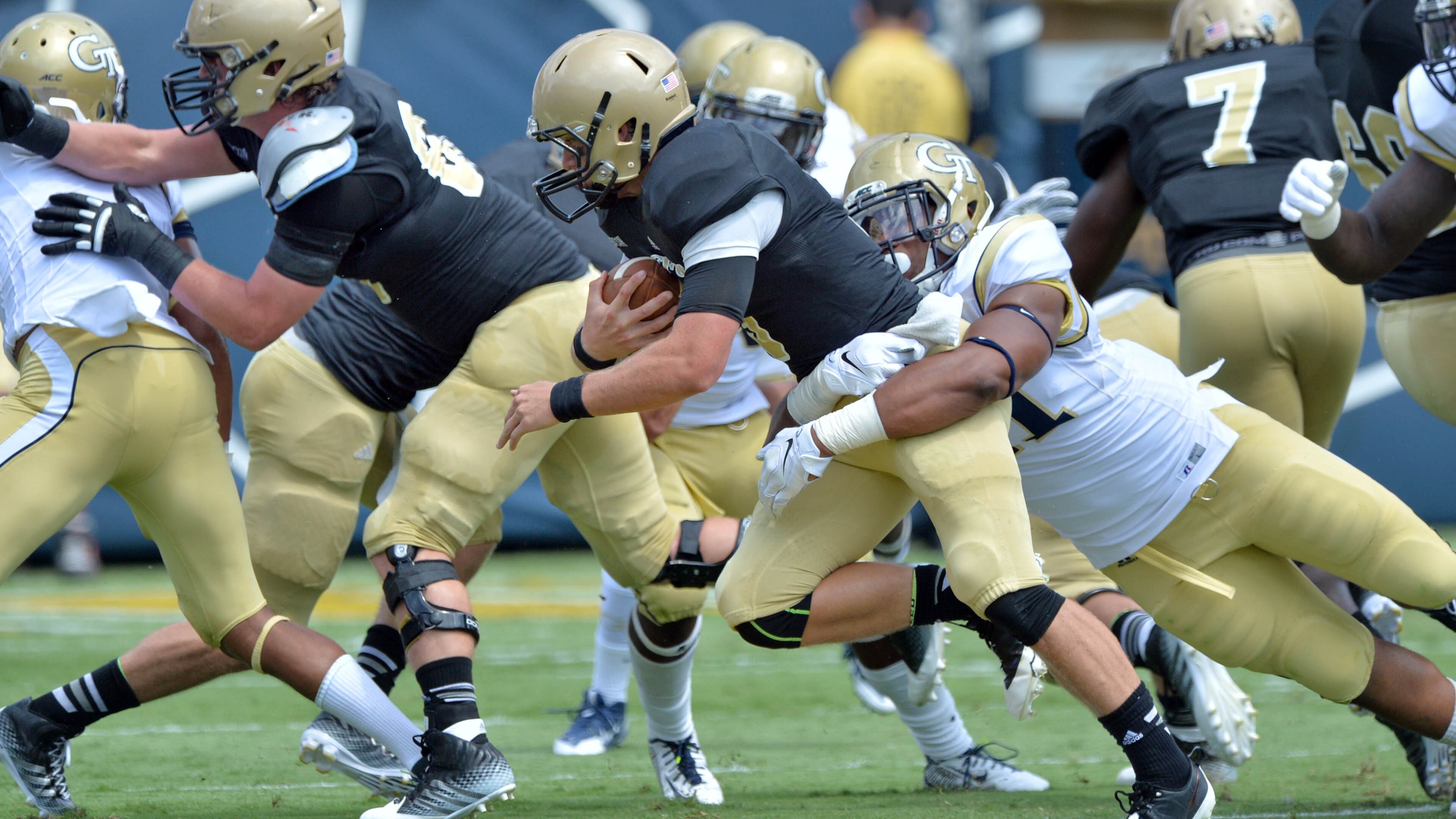 August 30, 2014 Atlanta - Wofford Terriers quarterback Evan Jacks (3) gets tackled from behind by Georgia Tech Yellow Jackets defensive lineman Patrick Gamble (91) in the first half of the Georgia Tech season opener at Bobby Dodd Stadium on Saturday, August 30, 2014. HYOSUB SHIN / HSHIN@AJC.COM