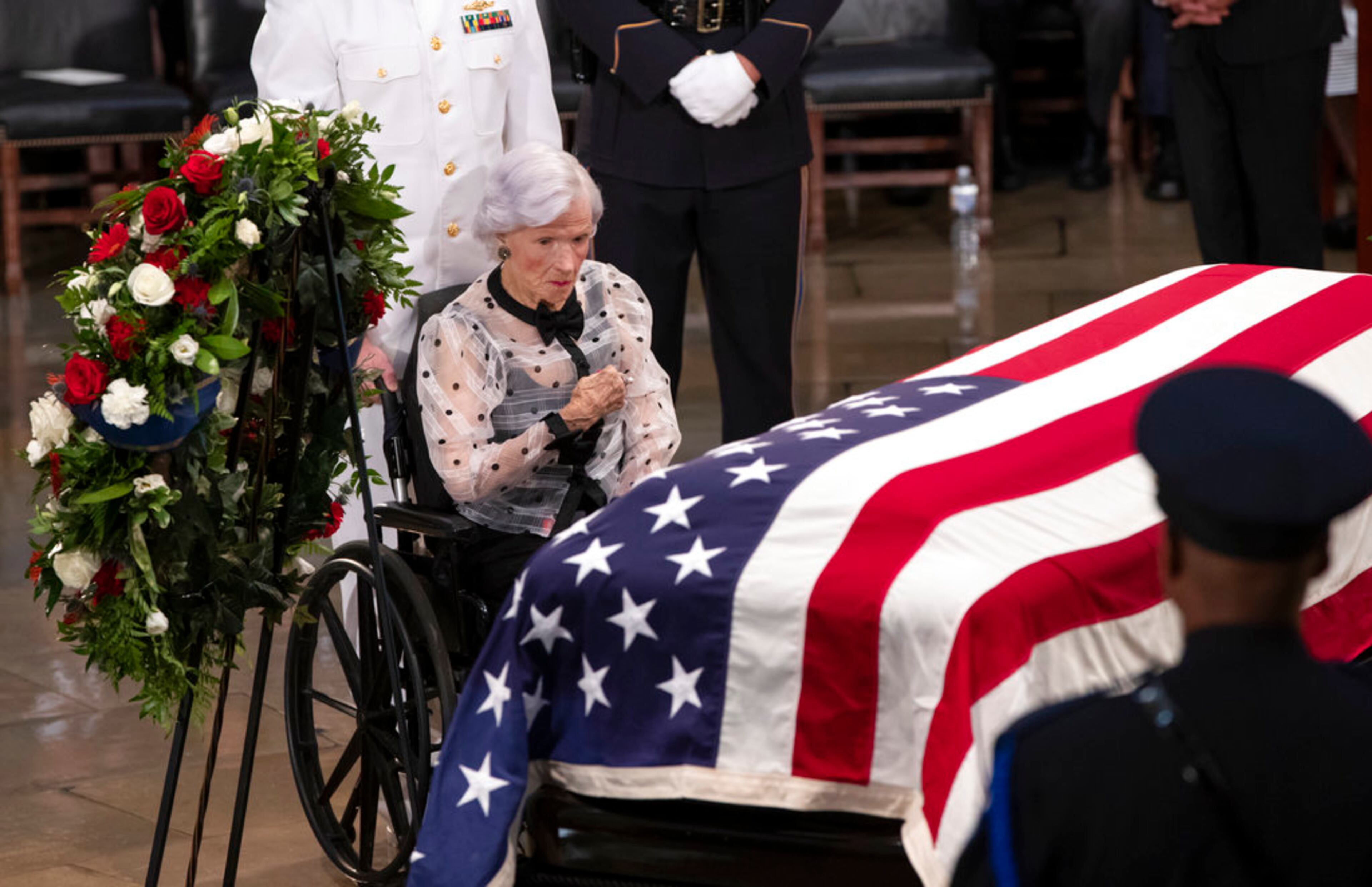 Roberta McCain, the 106-year-old mother of Sen. John McCain of Arizona, stops at his flag-draped casket in the U.S. Capitol rotunda during a farewell ceremony, Friday, Aug. 31, 2018, in Washington. (AP Photo/J. Scott Applewhite)