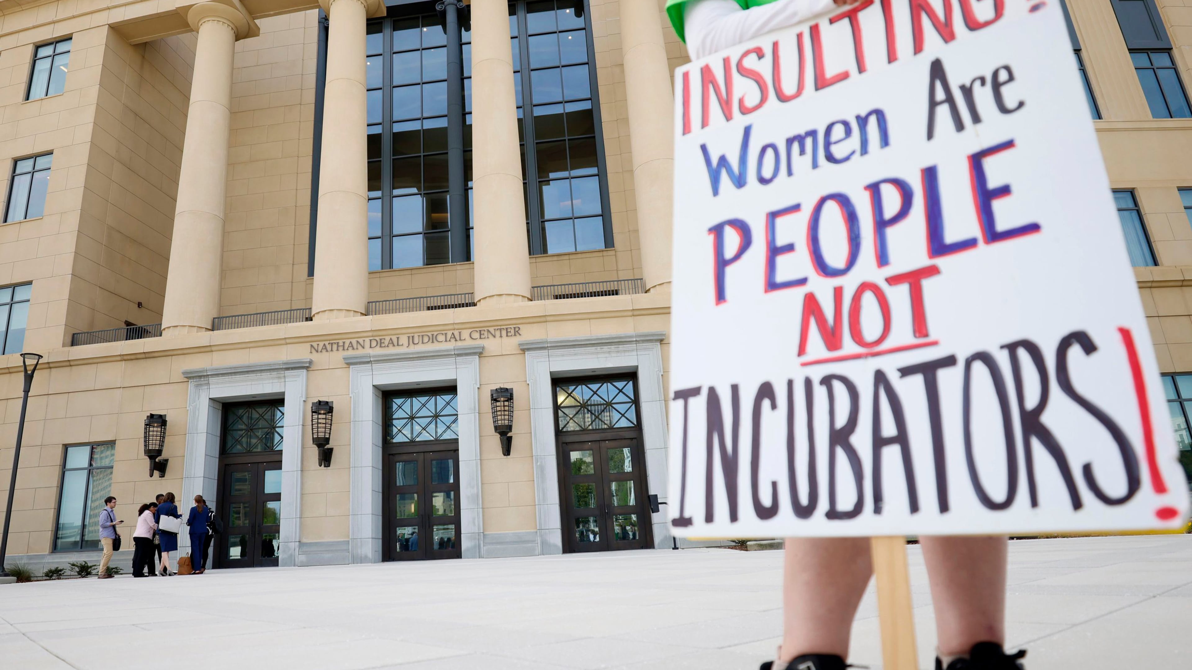 A protester holds a sign outside a Georgia Supreme Court hearing in the fight over the state's abortion law in March 2023. The case could unravel in 2026 under new legal precedent. (Miguel Martinez/AJC)