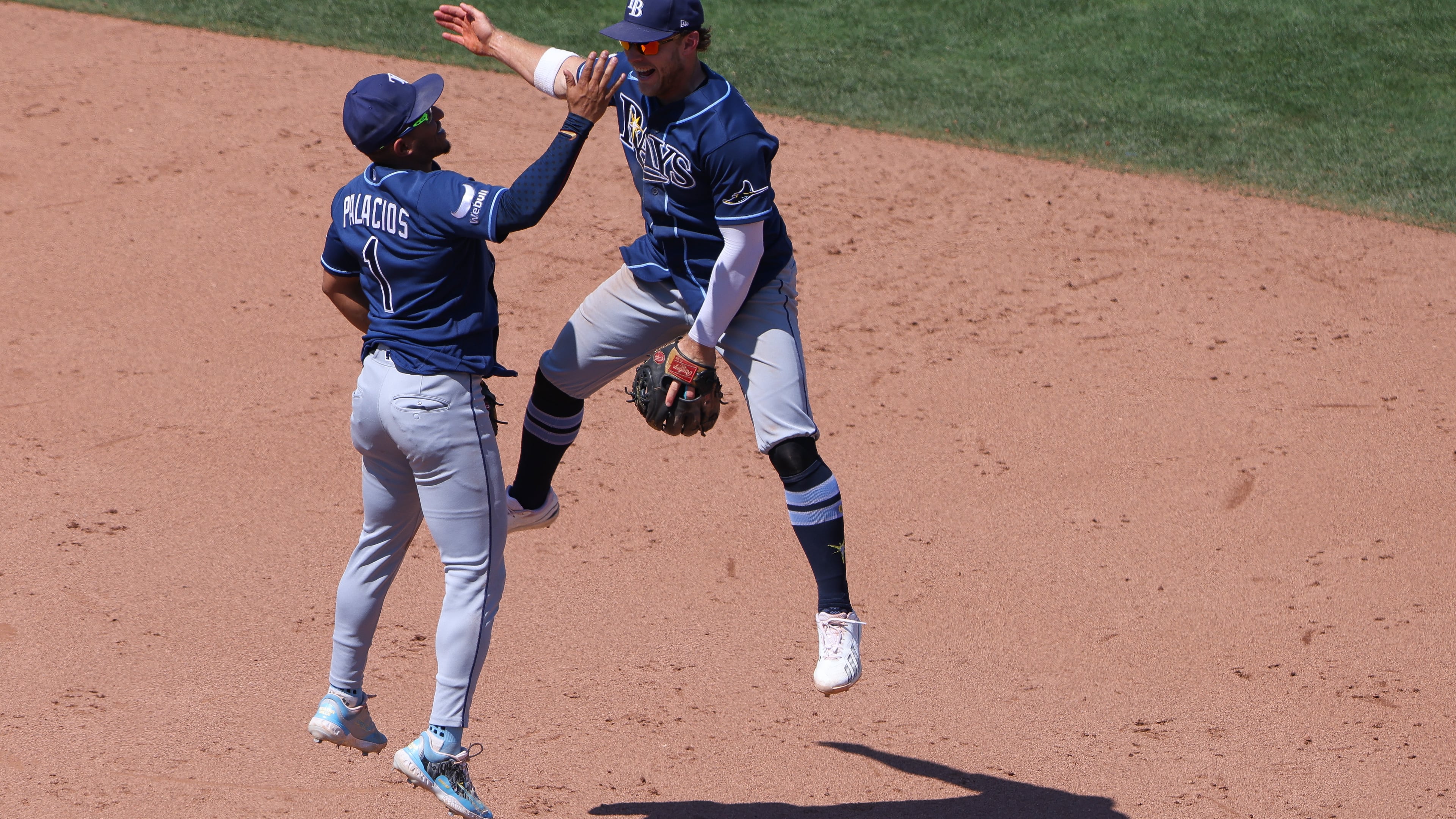 Tampa Bay Rays' Richie Palacios (1) and Taylor Walls, right, celebrate after the final out of a baseball game as the Rays defeat the Athletics Wednesday, Aug. 12, 2026, in West Sacramento, Calif. (AP Photo/Scott Marshall)