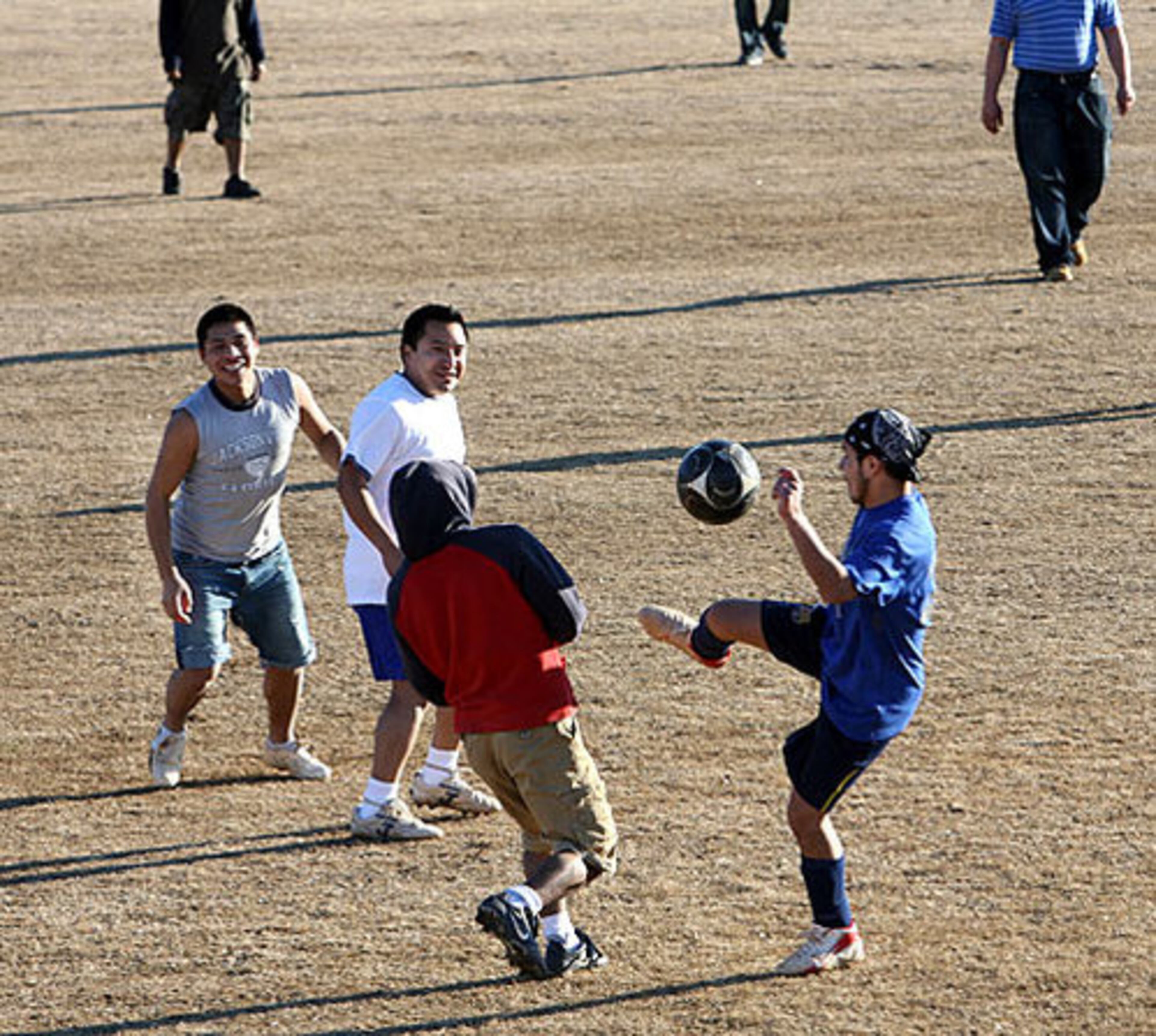 Men play soccer at at Heritage Park in Canton.
