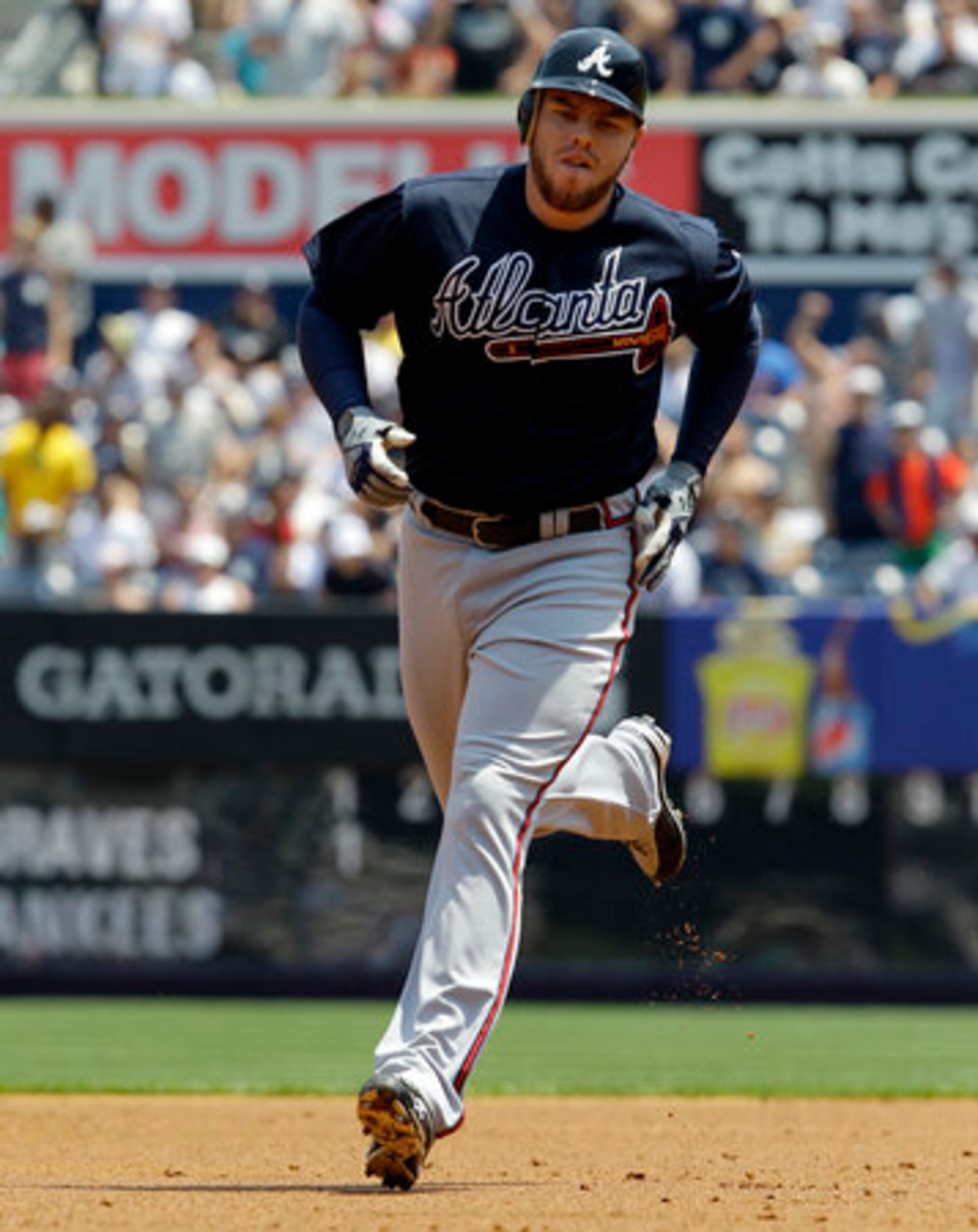 Atlanta Braves' Freddie Freeman trots around the bases after hitting a two-run home run off New York Yankees starting pitcher Phil Hughes during first inning of a baseball game at Yankee Stadium in New York, Wednesday, June 20, 2012.