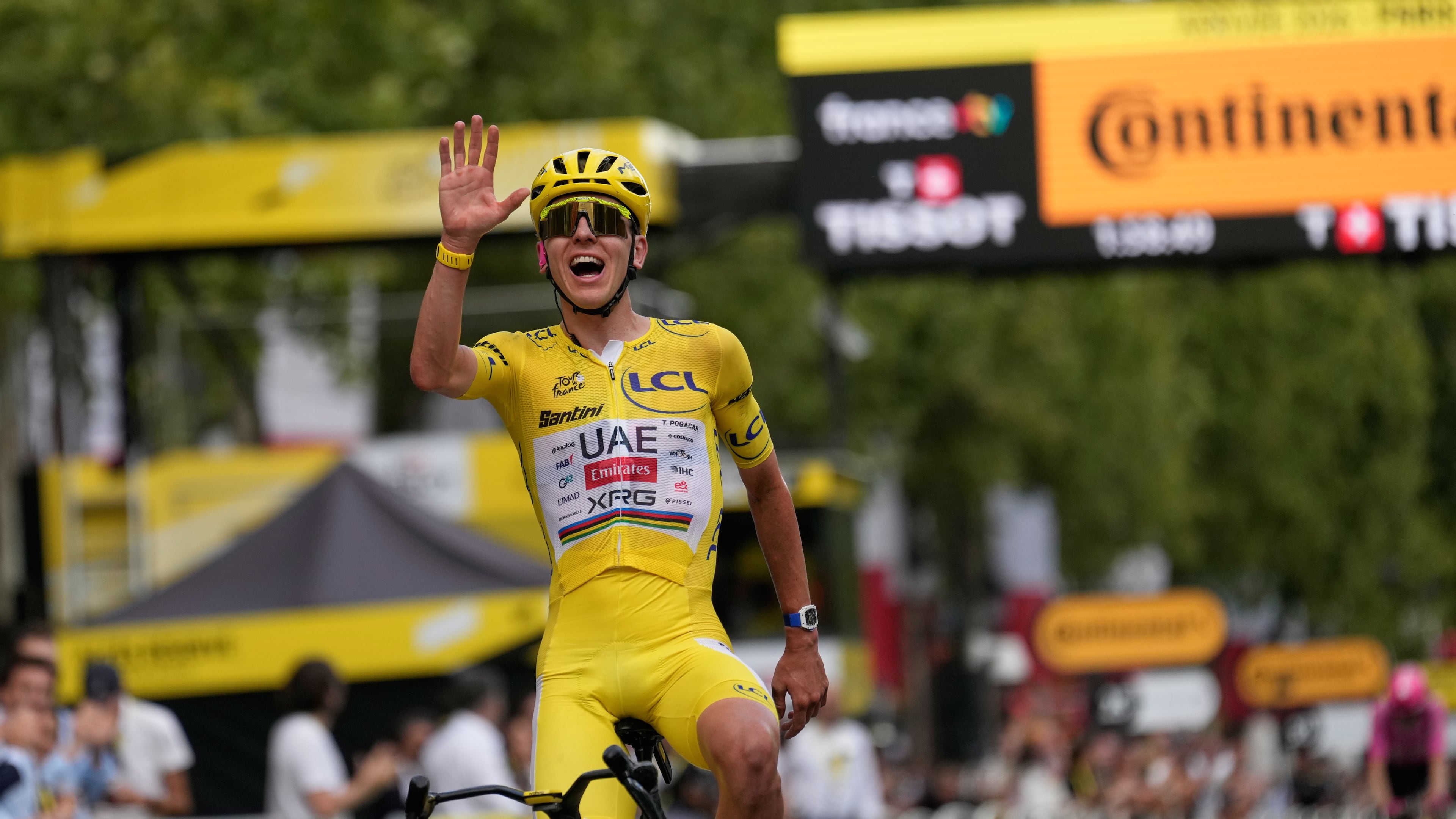 Slovenia's Tadej Pogacar, wearing the overall leader's yellow jersey, celebrates as he crosses the finish line of the last stage of the Tour de France cycling race with start and finish in Paris, Sunday, July 26, 2026. (AP Photo/Mosa'ab Elshamy)