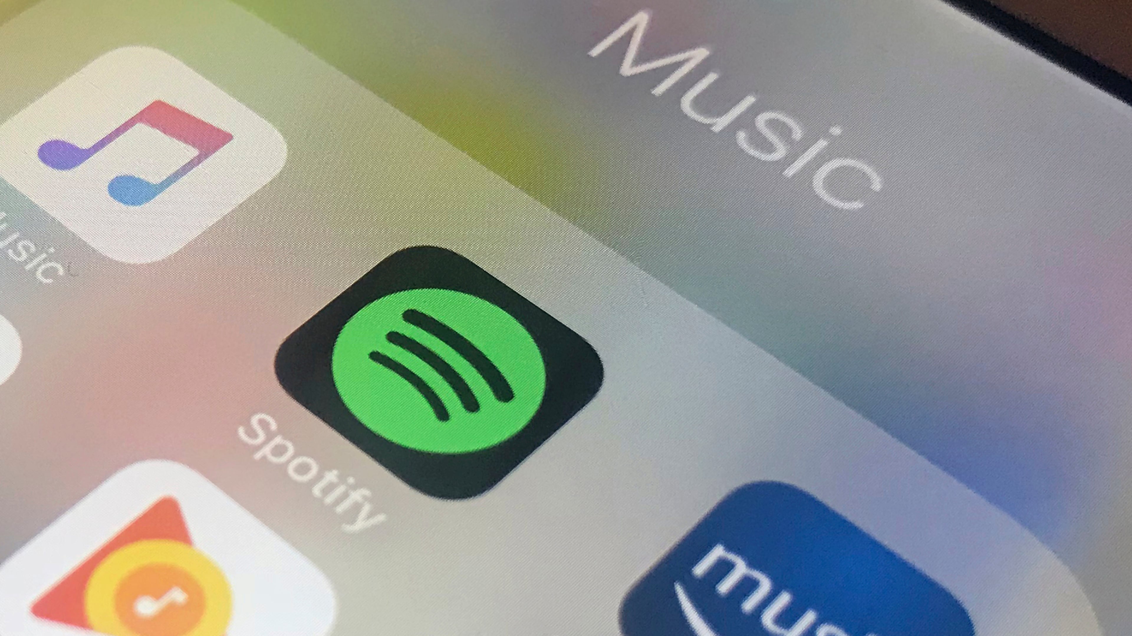 FILE - Music streaming apps, clockwise from top left, Apple, Spotify, Amazon and Google are displayed on an iPhone in New York, Jan. 28, 2018. (AP Photo/Jenny Kane, File)