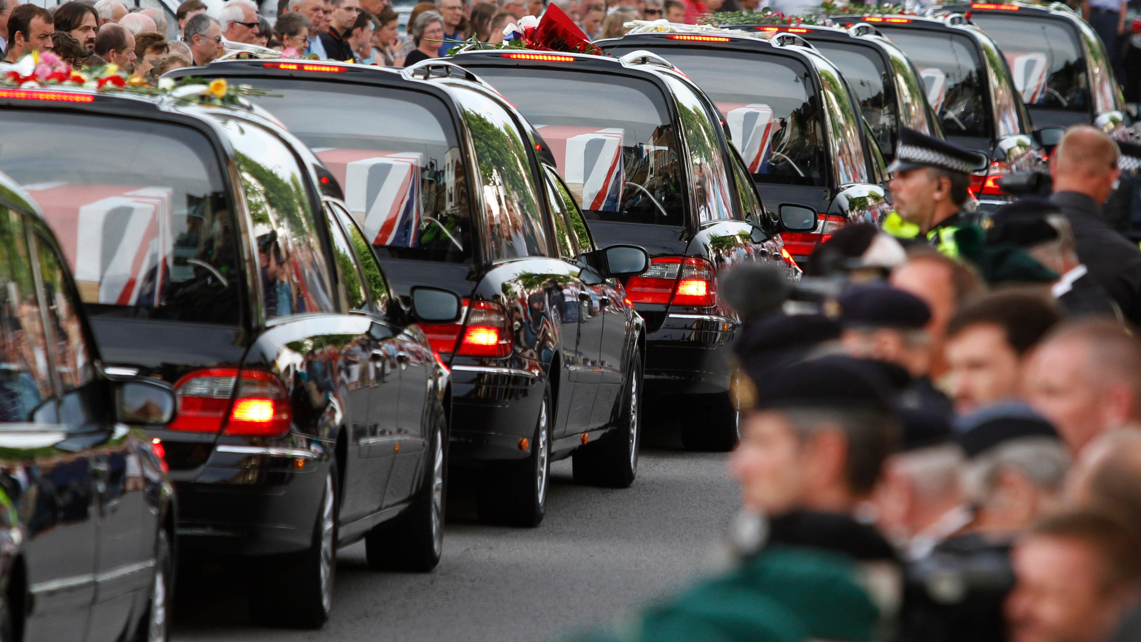 FILE - The coffins of seven British soldiers killed in Afghanistan, are driven through the town of Wootton Bassett, England, after repatriation to Britain, Tuesday, June 29, 2010. (AP Photo/Lefteris Pitarakis, file)