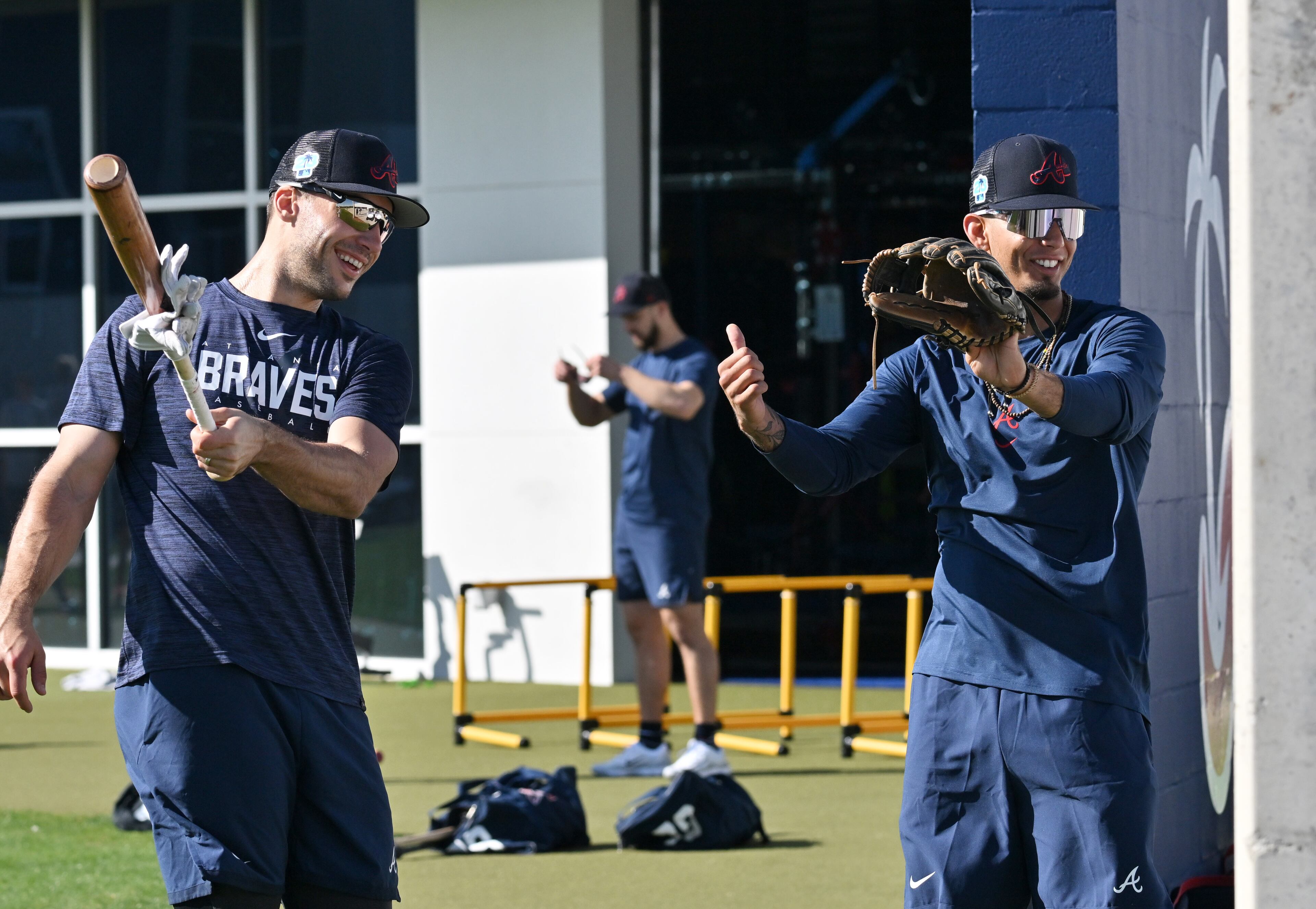 Braves first baseman Matt Olson (left) and infielder Vaughn Grissom share a smile as they warm up during spring training Thursday at CoolToday Park in North Port, Florida. (Hyosub Shin / Hyosub.Shin@ajc.com)