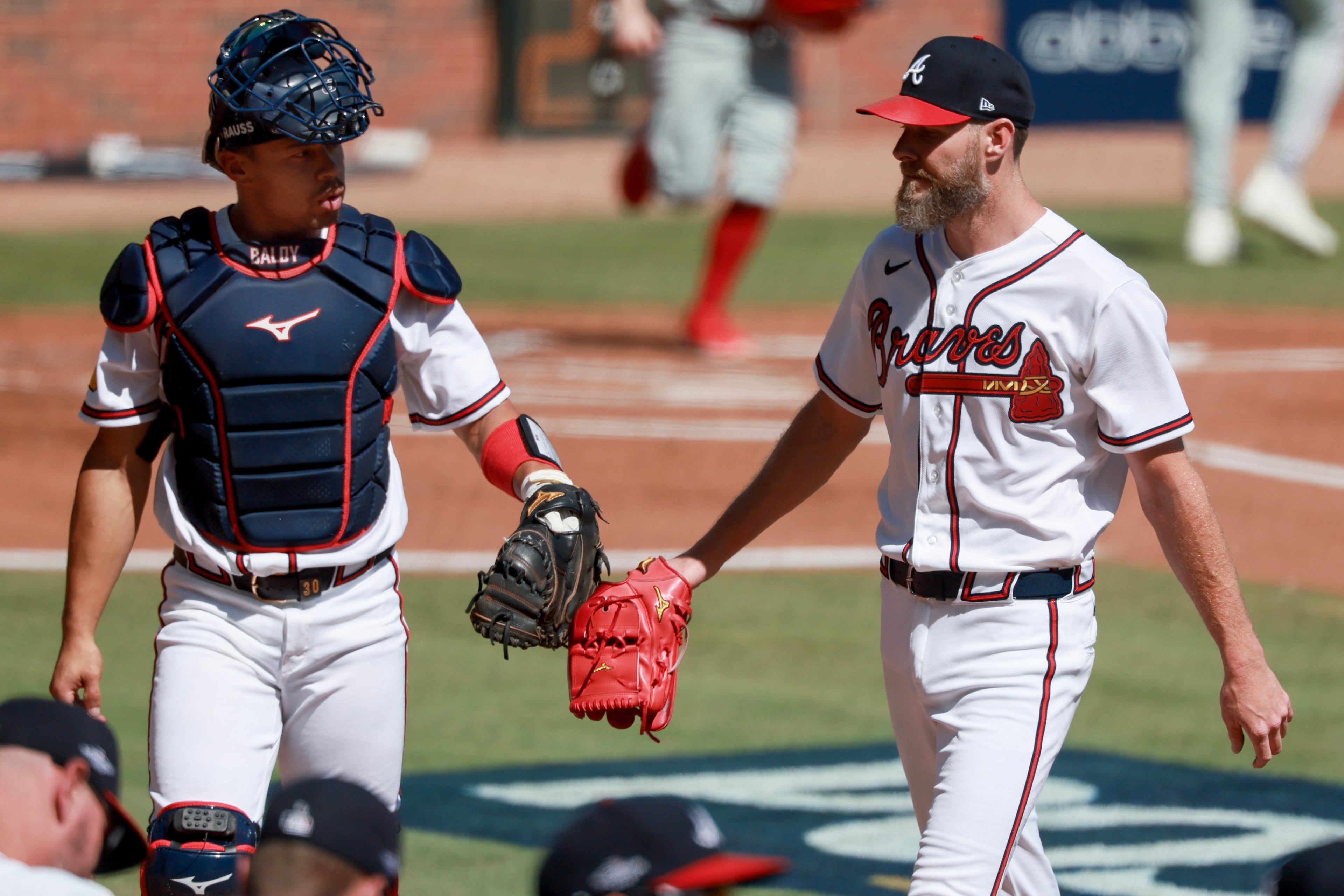 Atlanta Braves pitcher Chris Sale, right, greets catcher Drake Baldwin after facing the Philadelphia Phillies during the first inning of Game 1 of a MLB National League Wild Card playoff series between the Atlanta Braves and the Philadelphia Phillies, Tuesday, Sept. 29, 2026, in Atlanta. (Jason Getz/AJC)