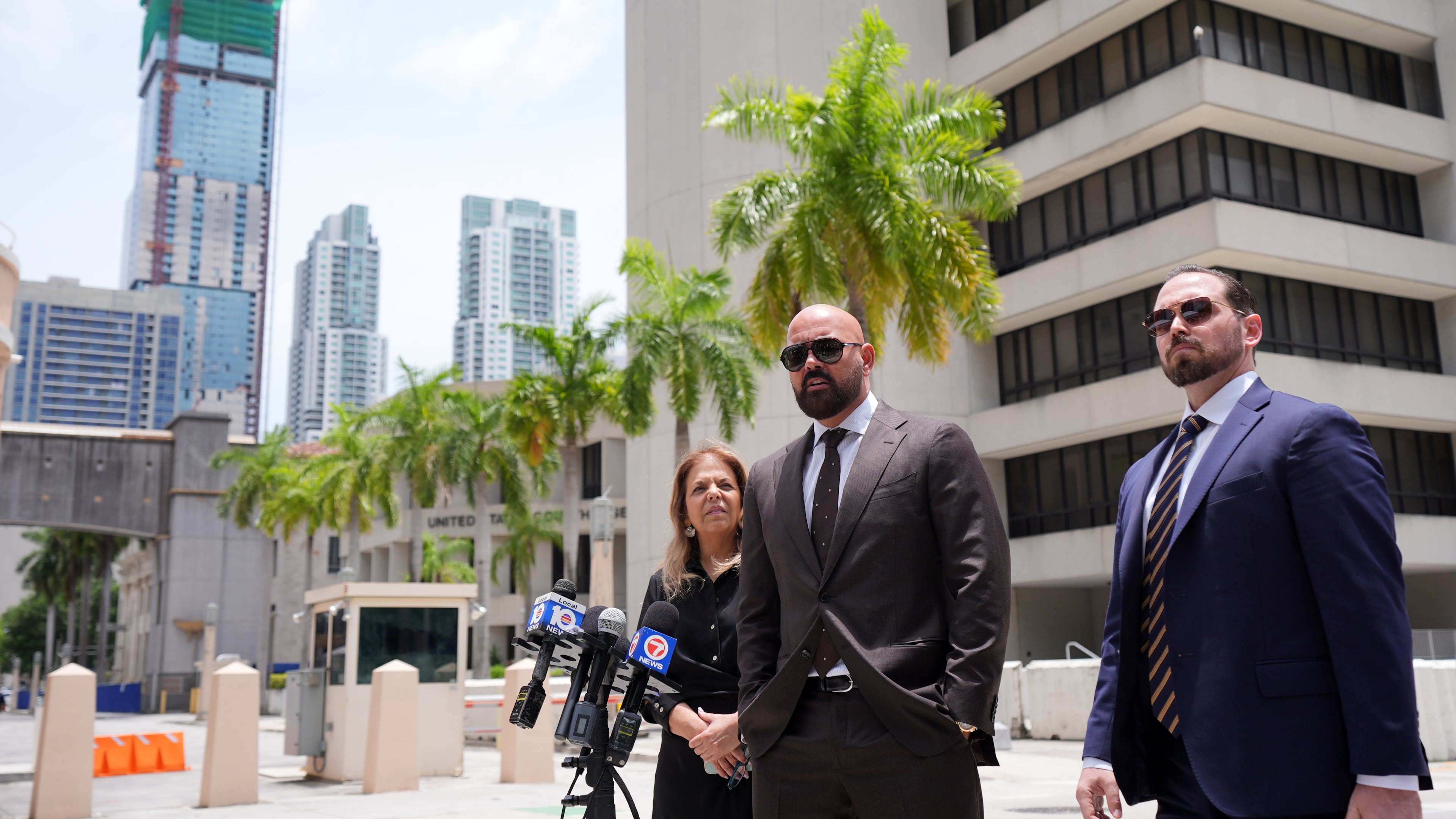 Attorneys Joseph McBride, center, and Jackie Perczek, left, representing Andrew and Tristan Tate as they fight extradition to the United Kingdom, where they are accused of rape and sex trafficking, speak to the media outside the C. Clyde Atkins U.S. Courthouse, Monday, July 27, 2026, in Miami. (AP Photo/Rebecca Blackwell)