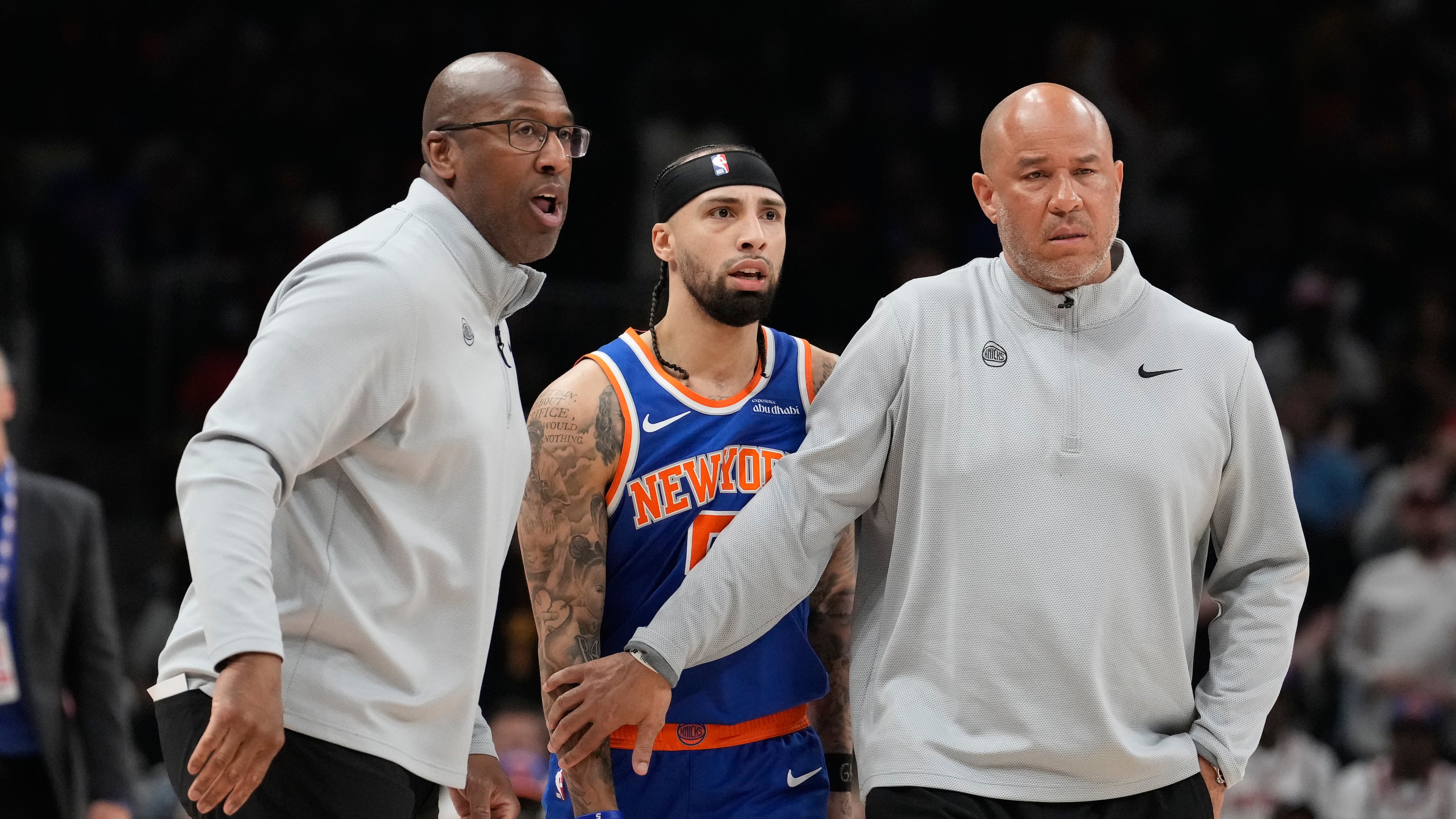 New York Knicks head coach Mike Brown holds back New York Knicks guard Jose Alvarado (5) with another coach during the first half of Game 4 in a first-round NBA playoffs basketball series against the Atlanta Hawks Saturday, April 25, 2026, in Atlanta. (AP Photo/Brynn Anderson)