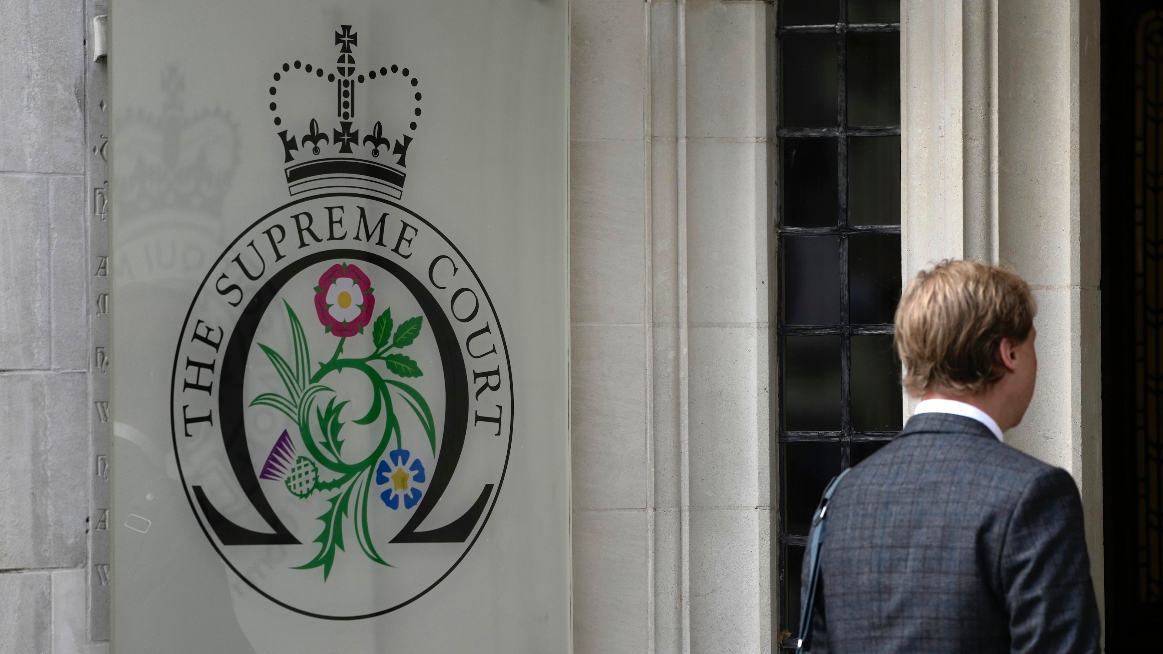 FILE - A man enters the Supreme Court in London, on Oct. 9, 2023. (AP Photo/Kin Cheung, File)