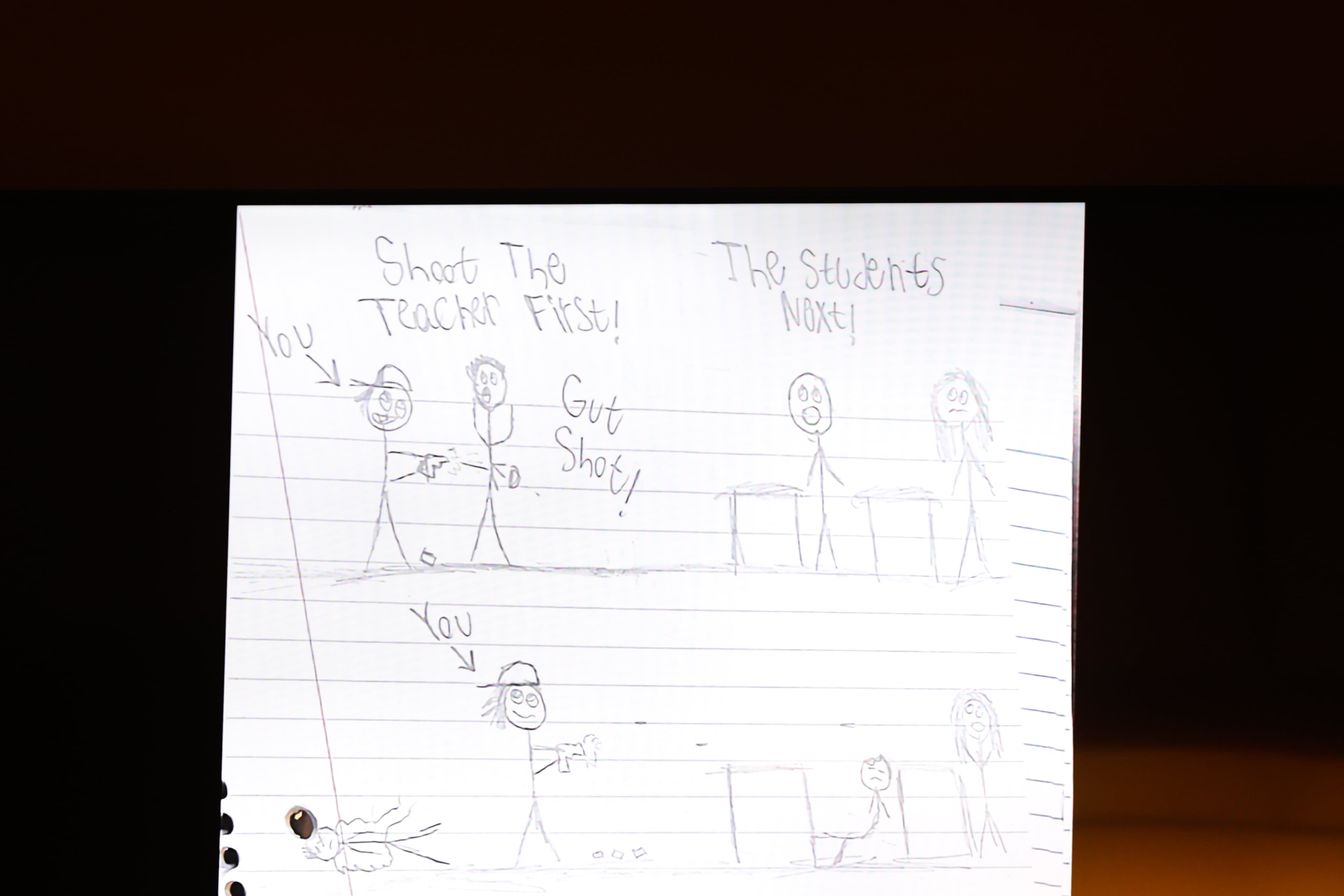 A screen displays the words “Shoot the teacher first” and other phrases from the notebook of the Apalachee High School shooter at his plea hearing at Barrow County Superior Court in Winder on July 24, 2026. (Arvin Temkar/AJC)