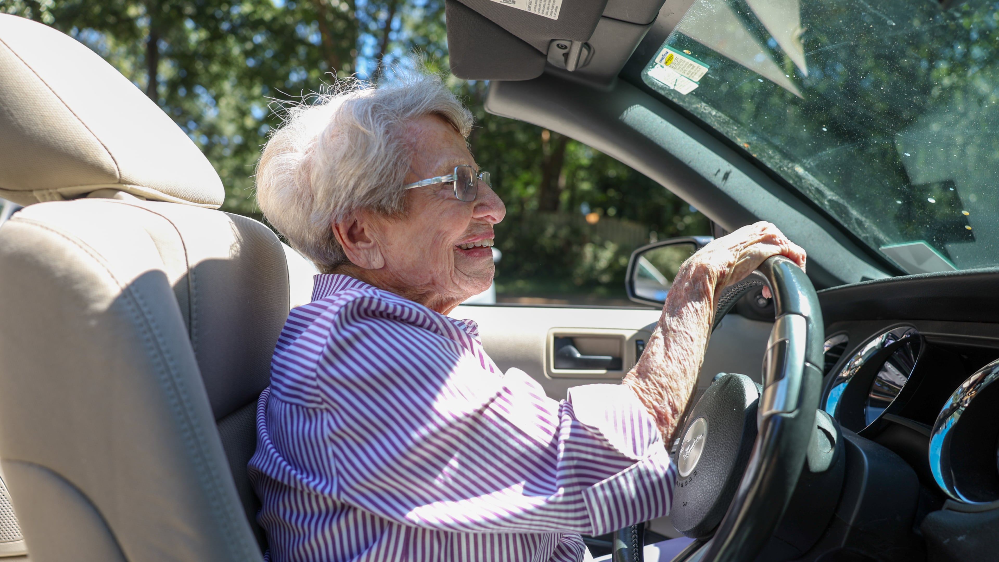 Barbara Haig, who turned 100 on Aug. 28, drives her white Ford Mustang convertible near her home in Atlanta on Wednesday, Sept. 9, 2026. (Arvin Temkar/AJC)